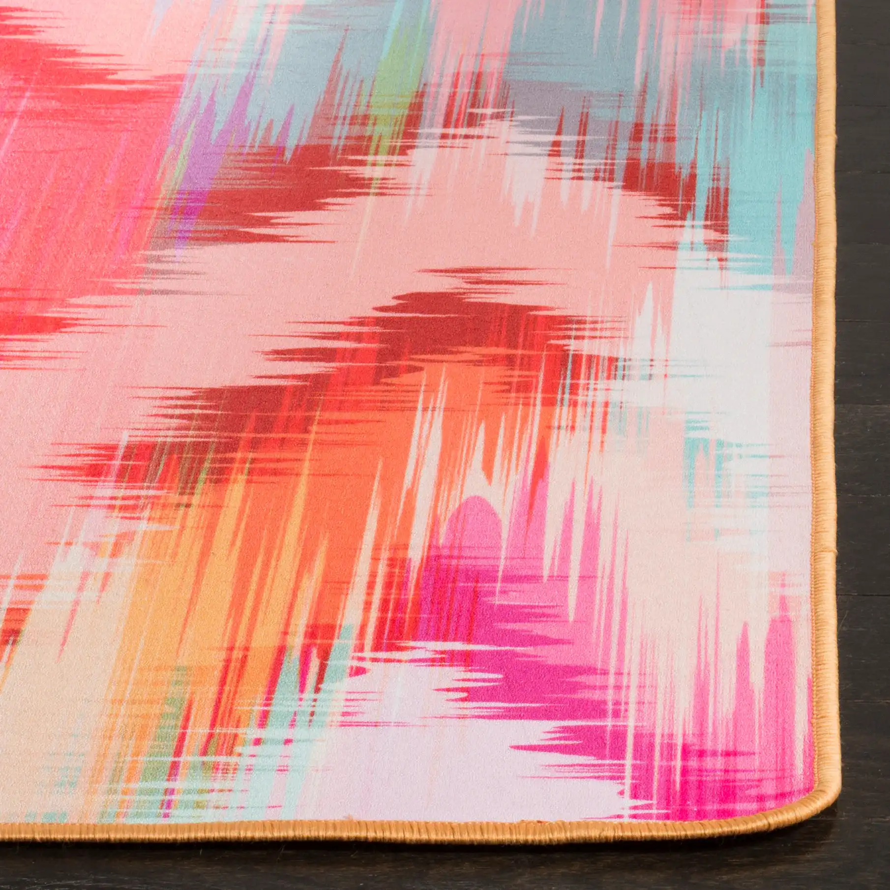 Daytona Chevron Washable Rug in Fuchsia / Orange in a styled room