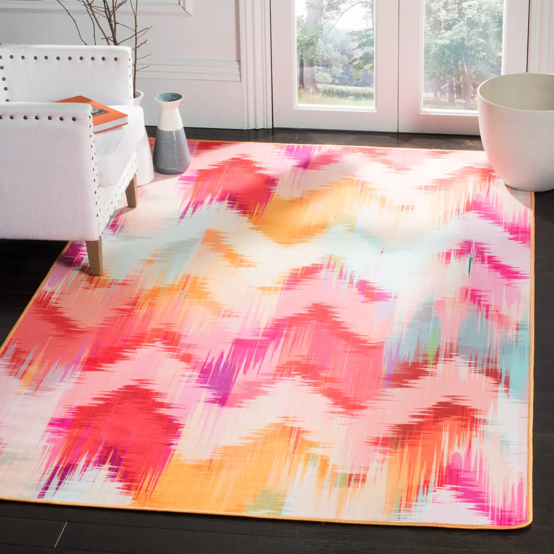 Daytona Chevron Washable Rug in Fuchsia / Orange in a styled room