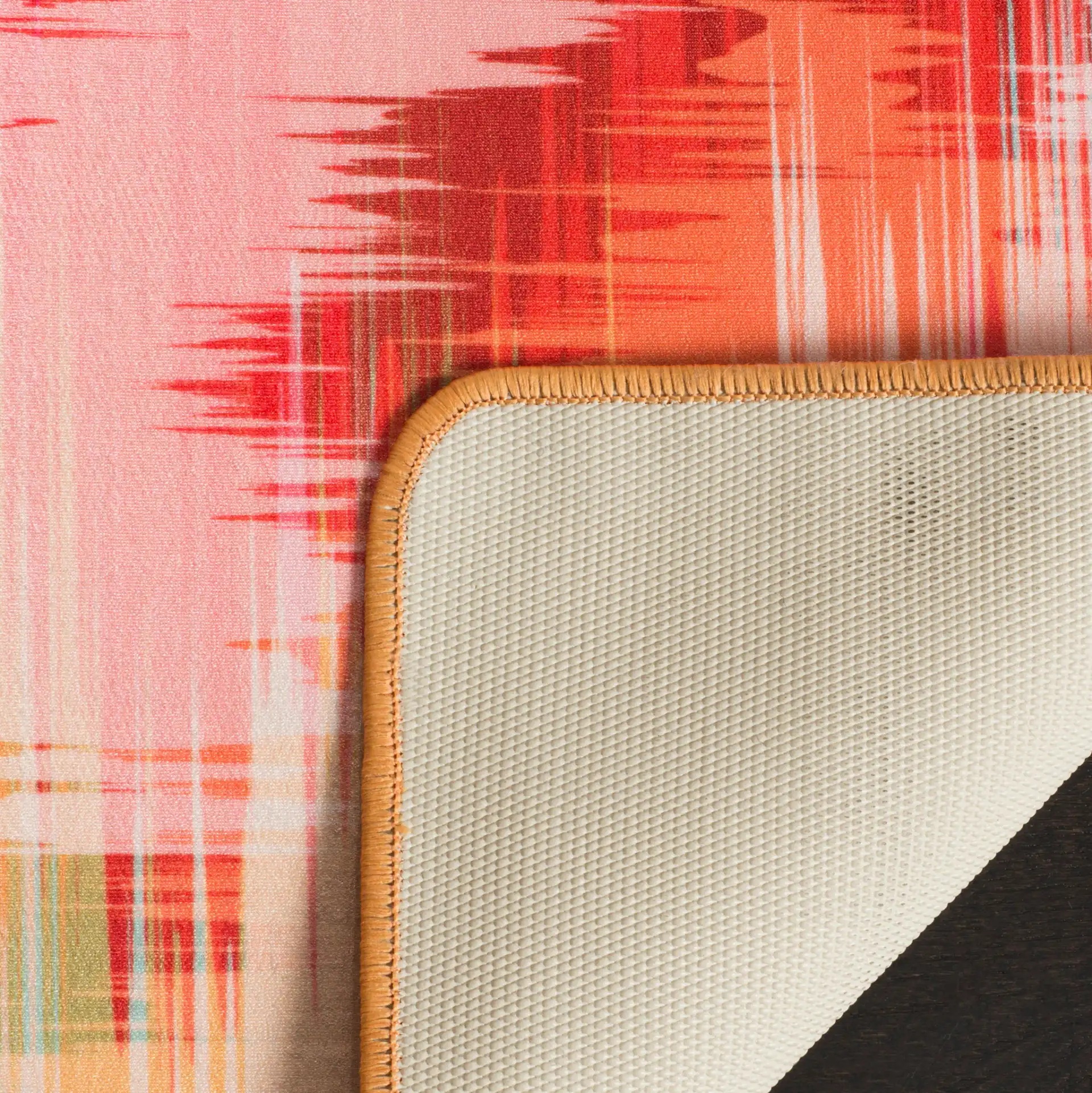 Daytona Chevron Washable Rug in Fuchsia / Orange in a styled room