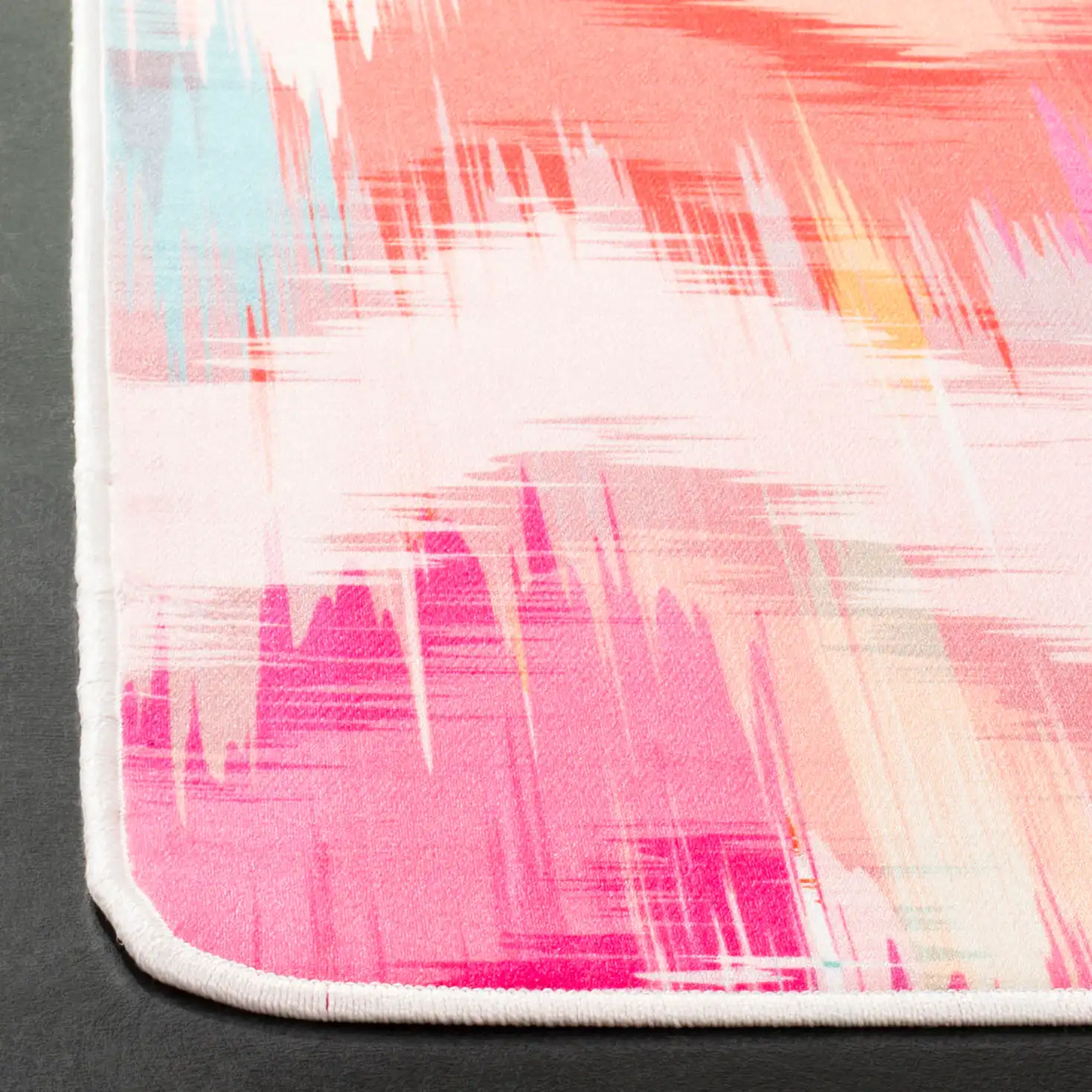 Daytona Chevron Washable Rug in Fuchsia / Orange in a styled room