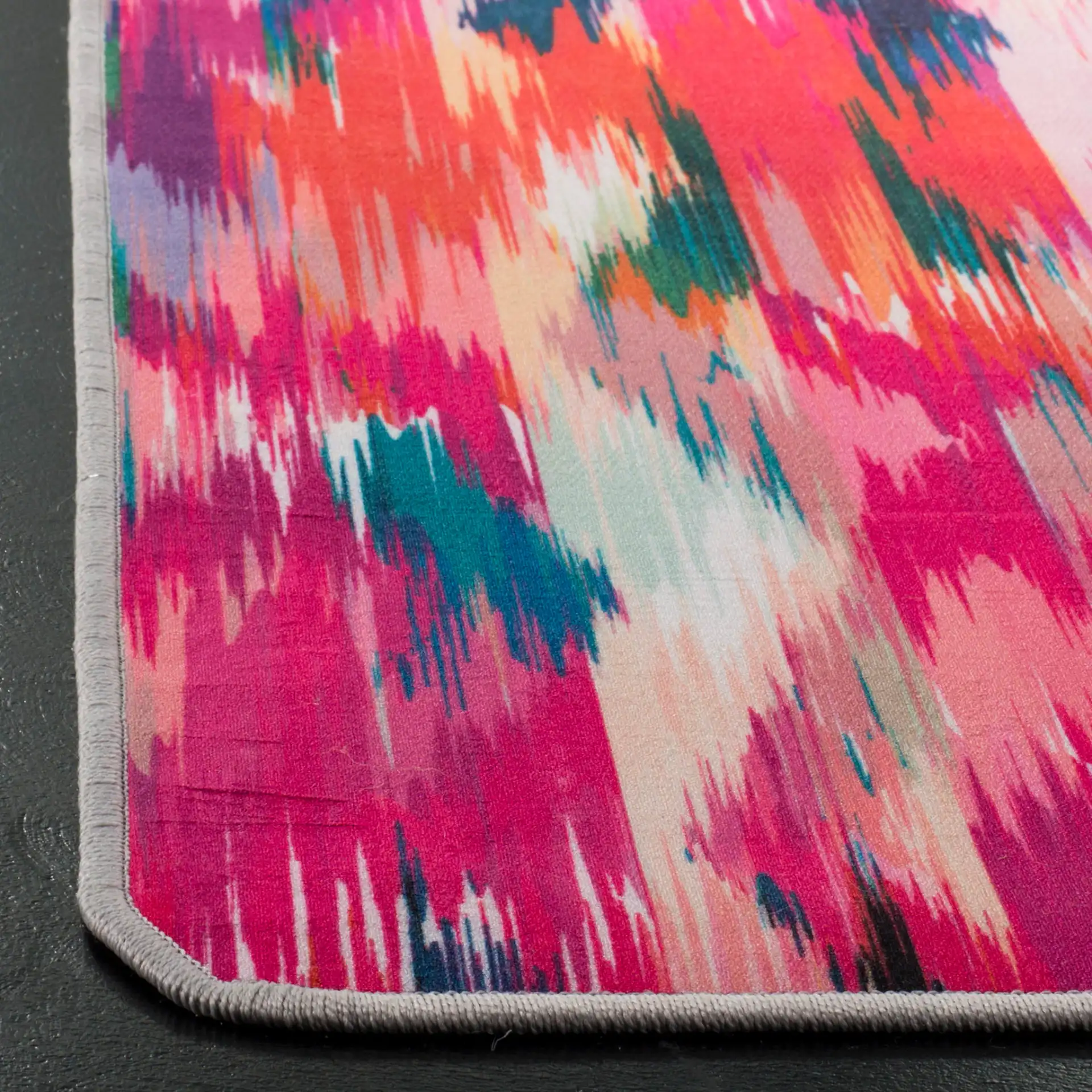 Daytona Ikat Washable Rug in Fuchsia / Purple in a styled room