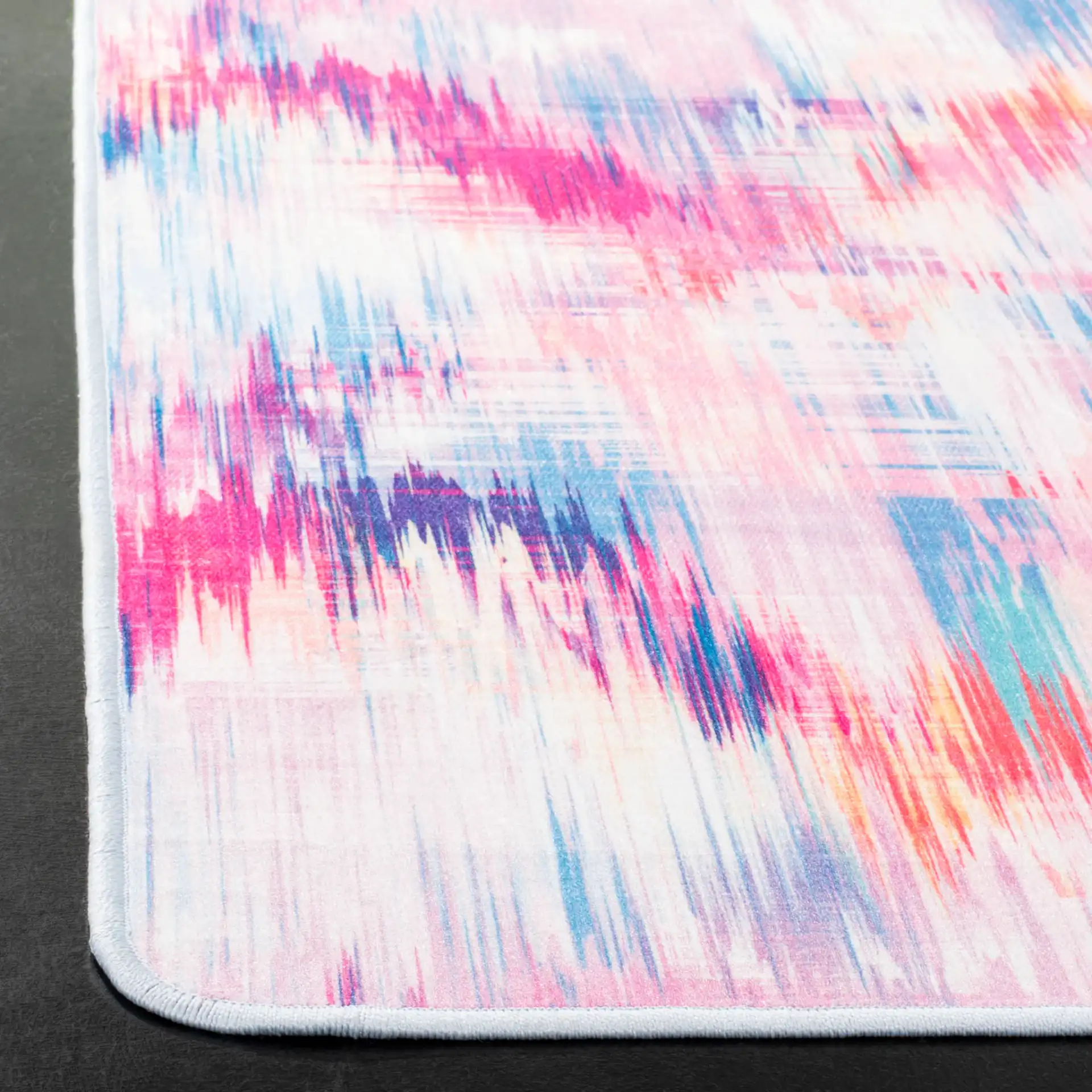 Daytona Ikat Diamond Washable Rug in Ivory / Pink in a styled room