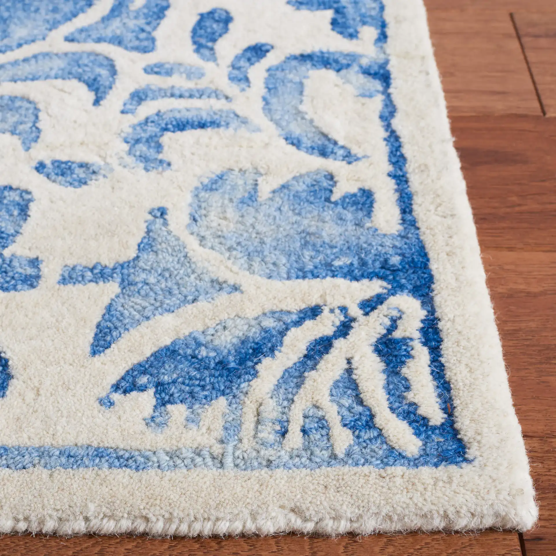 Dip Dye Scrollwork Hand-Tufted Wool Rug in Blue / Ivory in a styled room