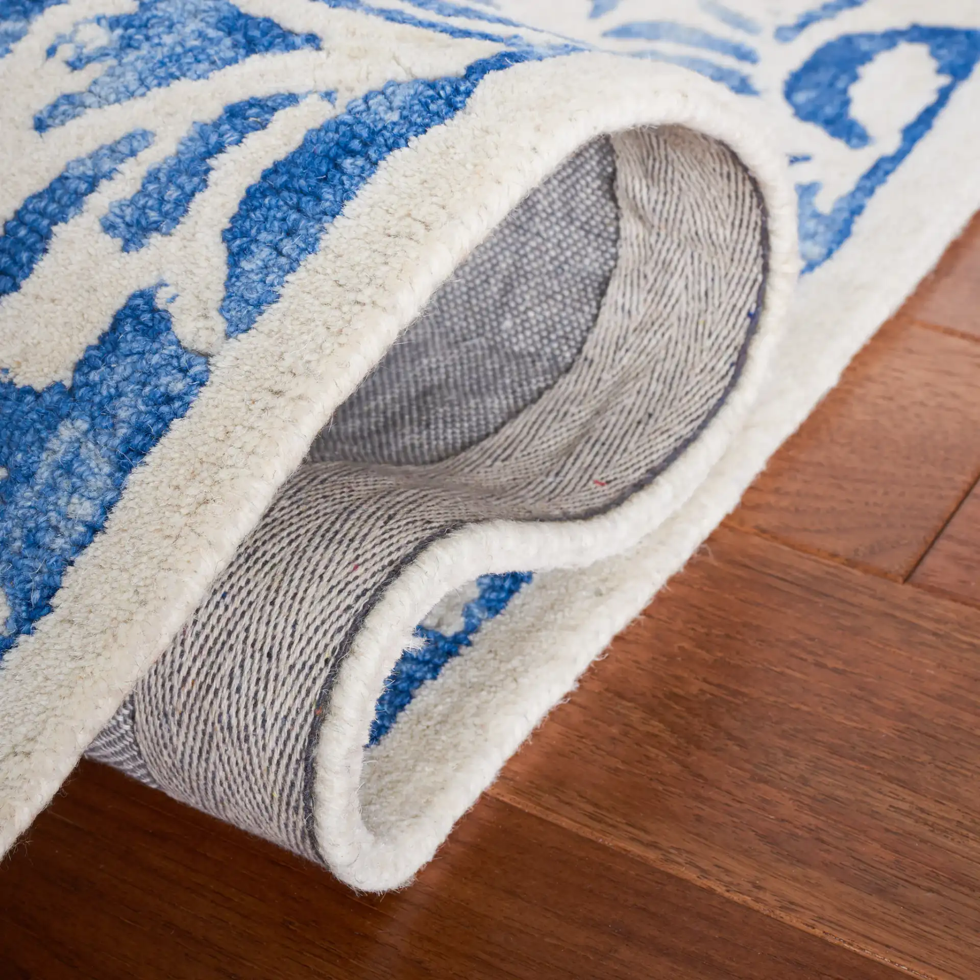 Dip Dye Scrollwork Hand-Tufted Wool Rug in Blue / Ivory in a styled room