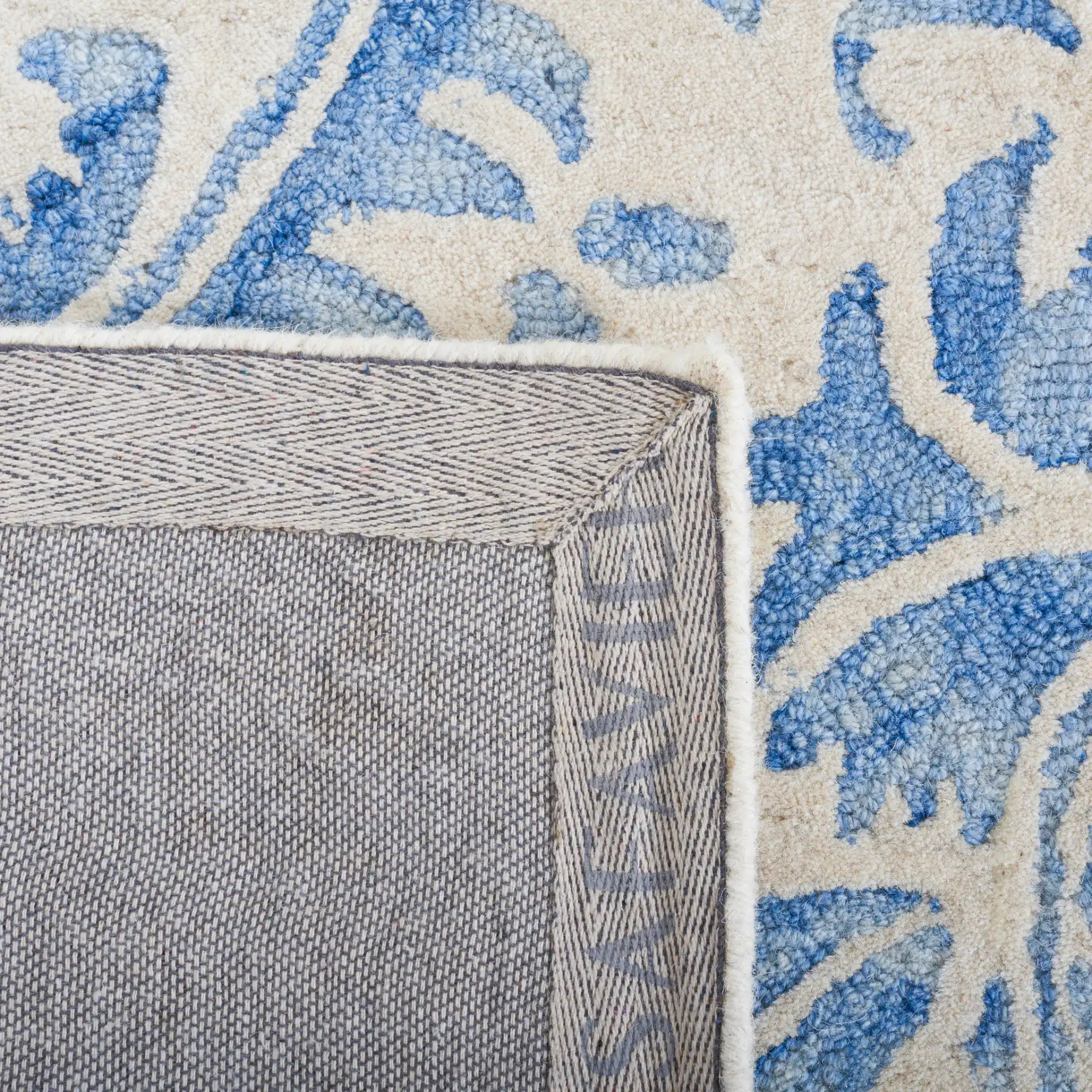 Dip Dye Scrollwork Hand-Tufted Wool Rug in Blue / Ivory in a styled room
