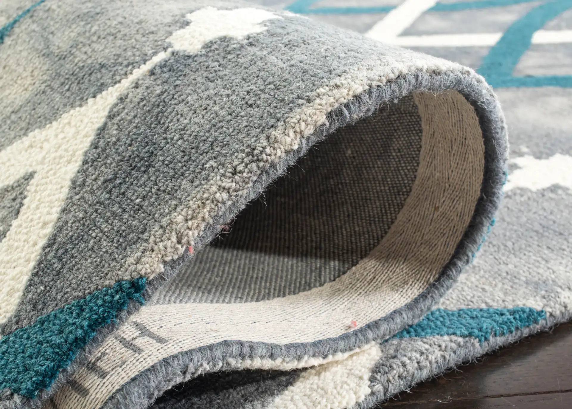 Dip Dye Interlocking Trellis Hand-Tufted Wool Rug in Gray / Ivory Blue in a styled room