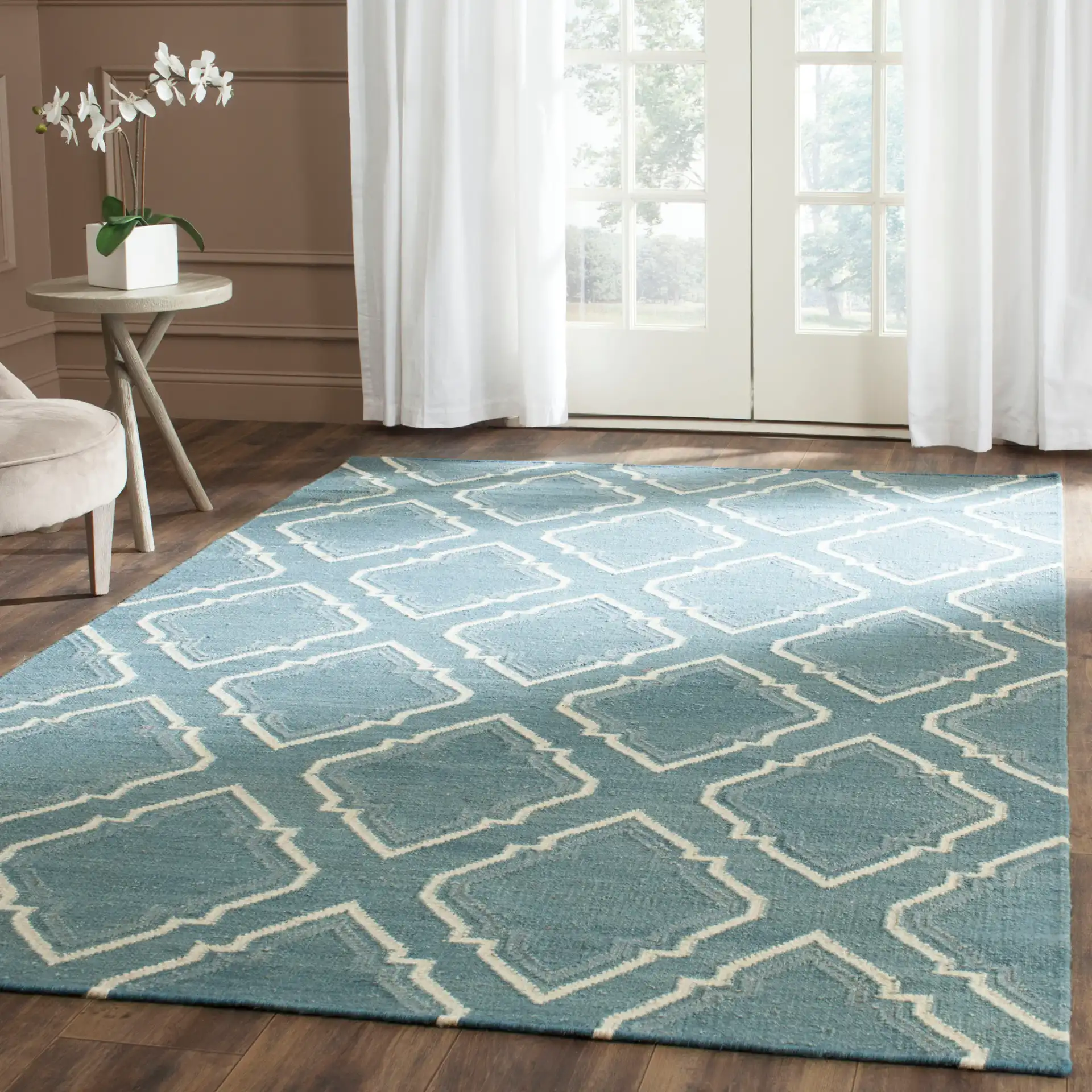 Dhurries Stepped Ogee Trellis Hand-Woven Wool Rug in Blue / Ivory in a styled room