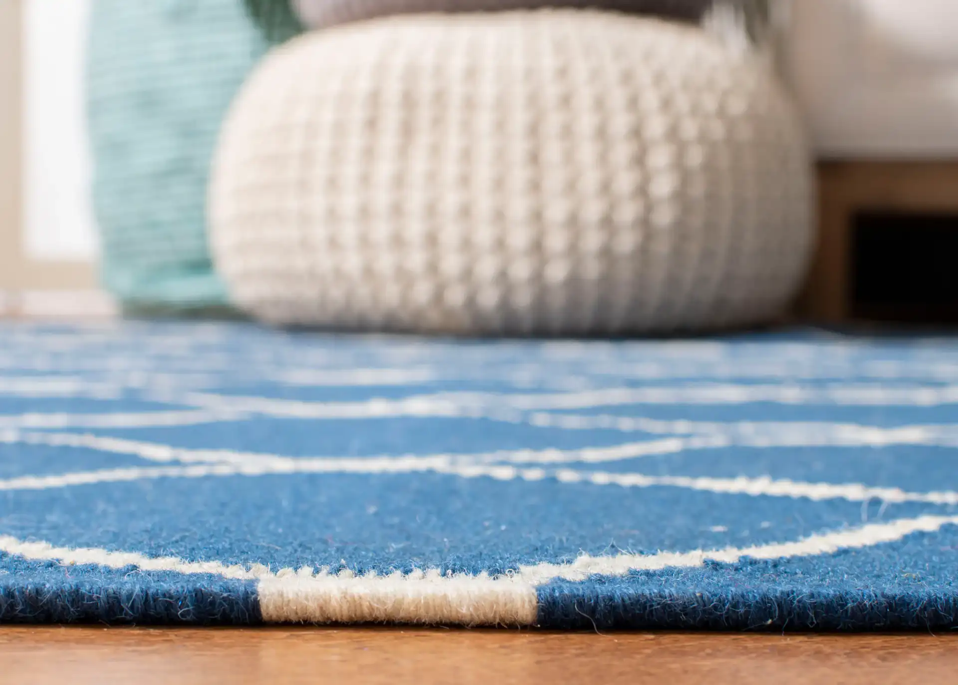 Dhurries Linked Trellis Hand-Woven Wool Rug in Dark Blue in a styled room