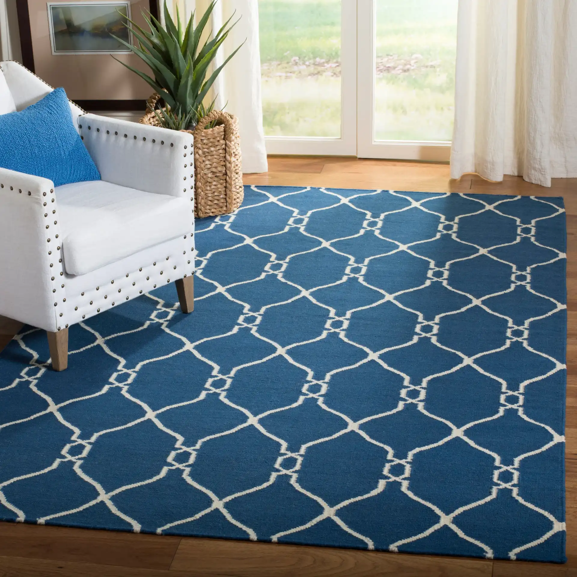 Dhurries Linked Trellis Hand-Woven Wool Rug in Dark Blue in a styled room