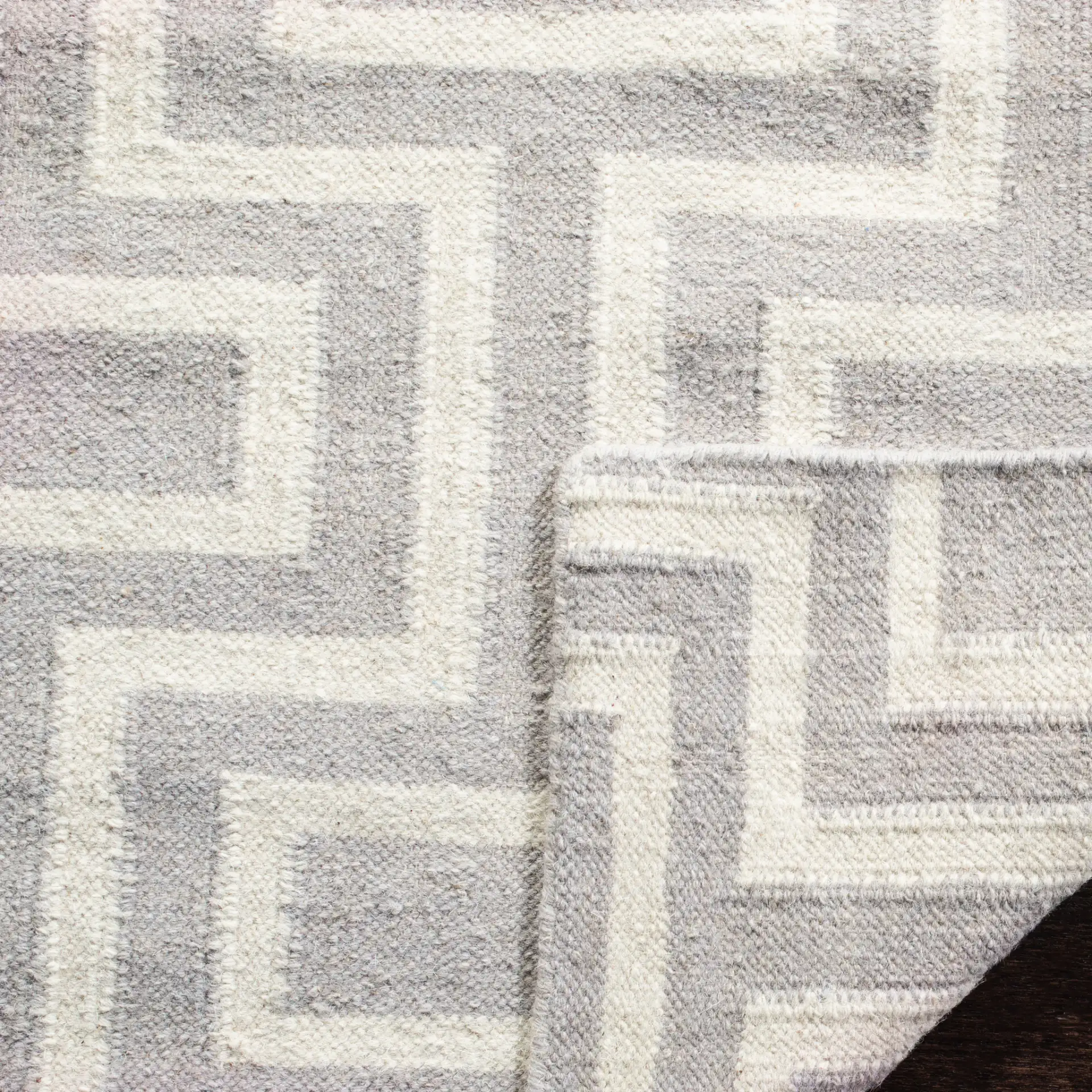 Dhurries Interlocking Rectangles Hand-Woven Rug in Gray / Ivory in a styled room