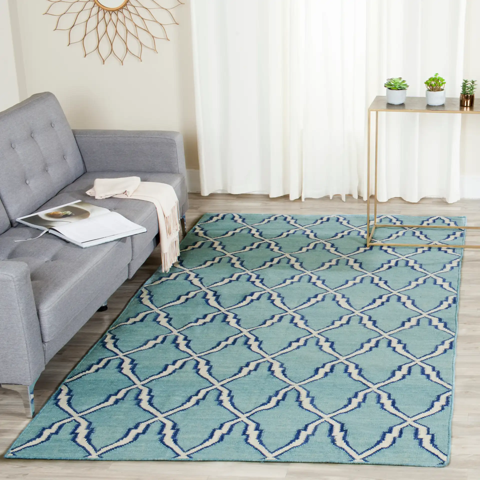 Dhurries Elongated Trellis Hand-Woven Rug in Light Blue / Ivory in a styled room