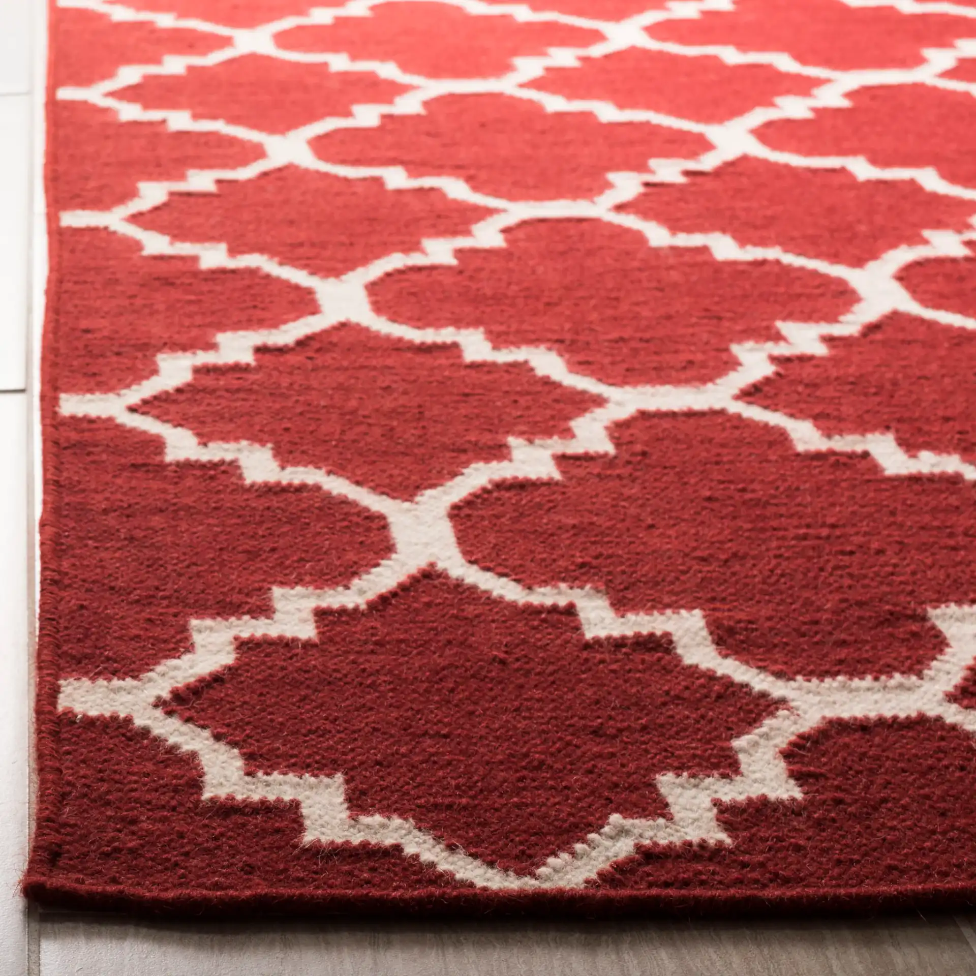 Dhurries Small-Scale Trellis Hand-Woven Rug in Red / Ivory in a styled room