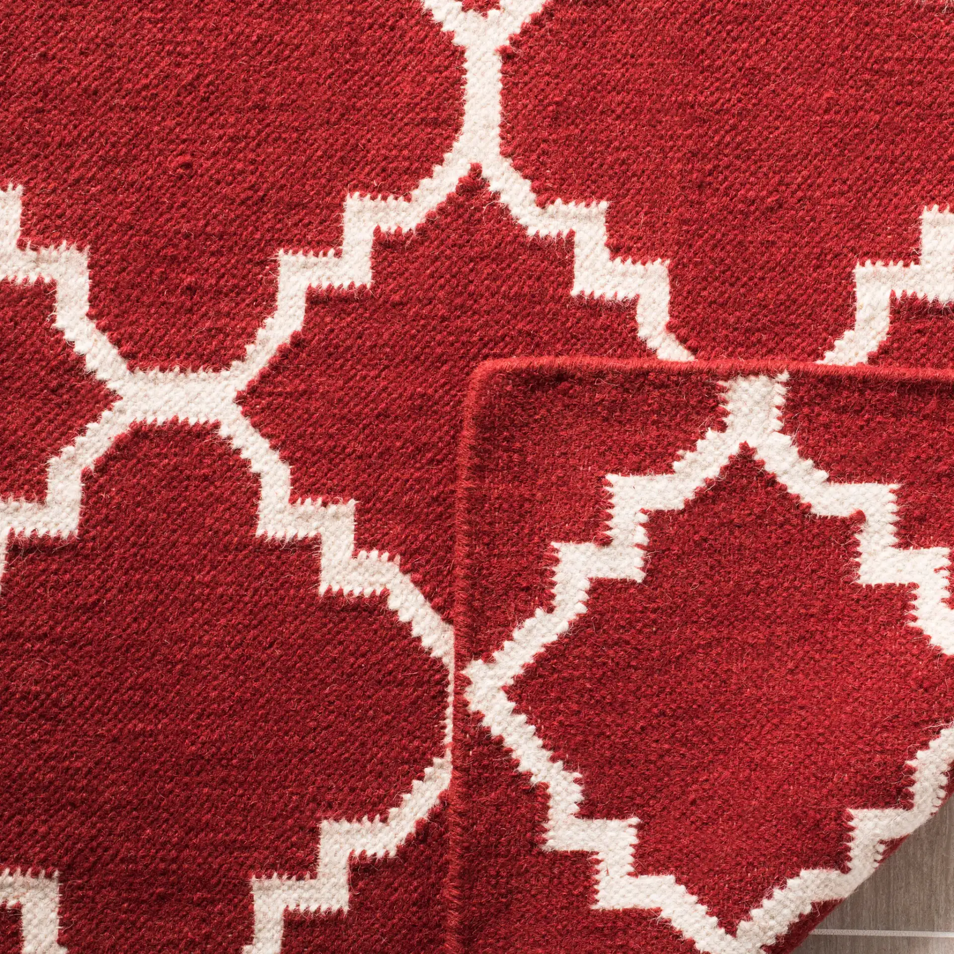 Dhurries Small-Scale Trellis Hand-Woven Rug in Red / Ivory in a styled room