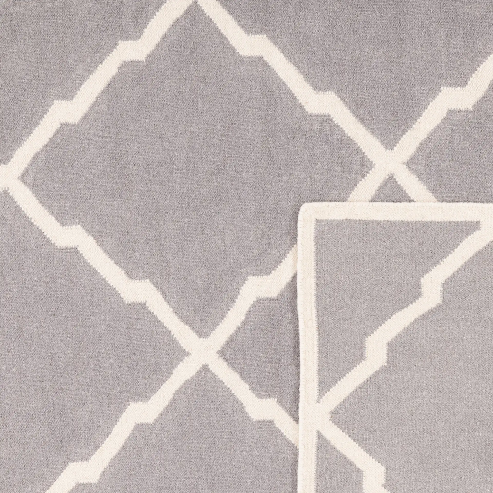 Dhurries Stepped Lattice Hand-Woven Rug in Gray / Ivory in a styled room