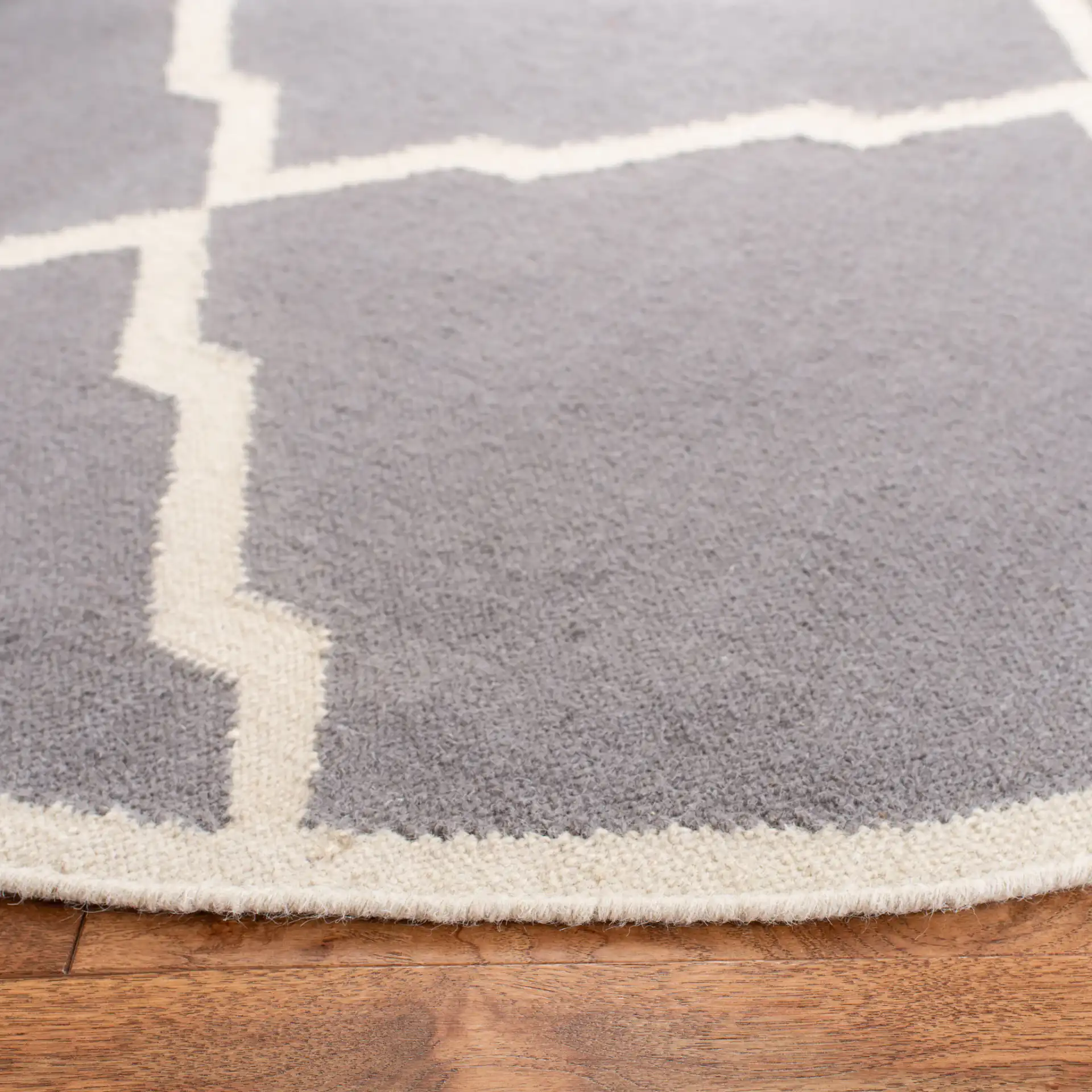 Dhurries Stepped Lattice Hand-Woven Rug in Gray / Ivory in a styled room