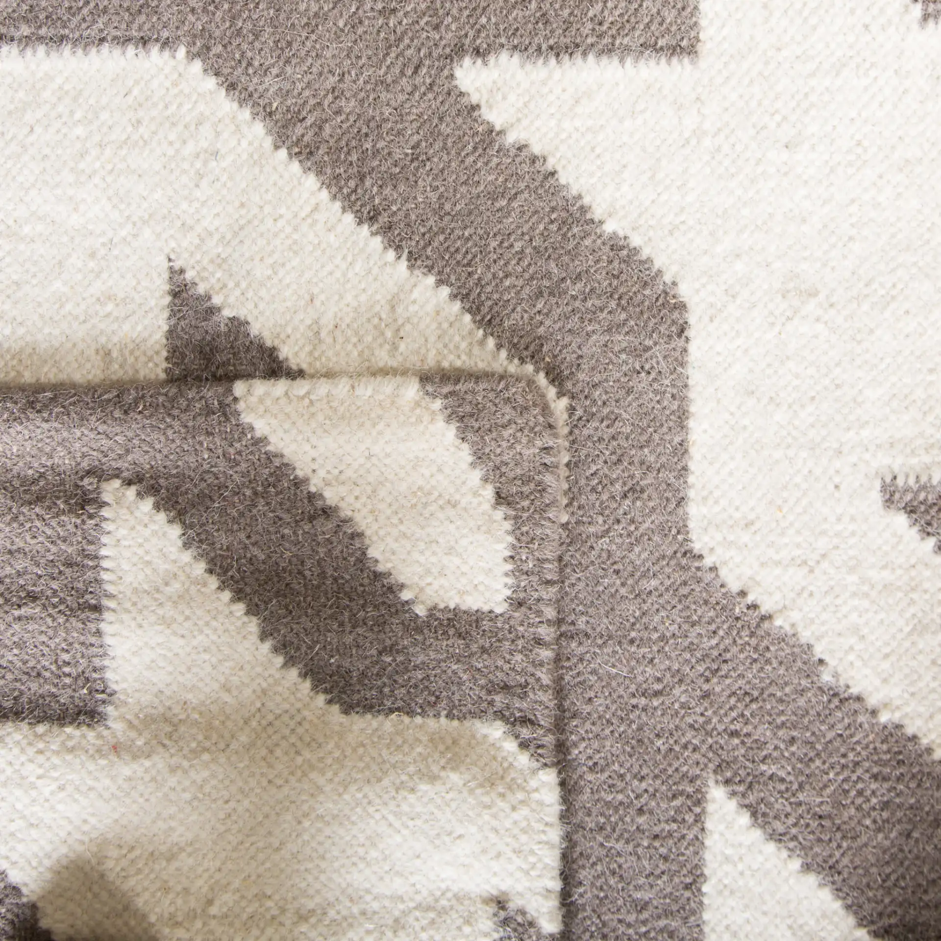Dhurries Houndstooth Hand-Woven Rug in Gray / Ivory in a styled room