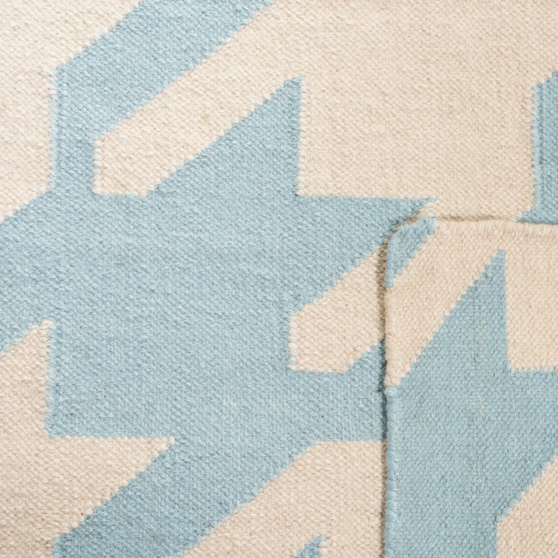 Dhurries Houndstooth Hand-Woven Wool Rug in Light Blue / Ivory in a styled room