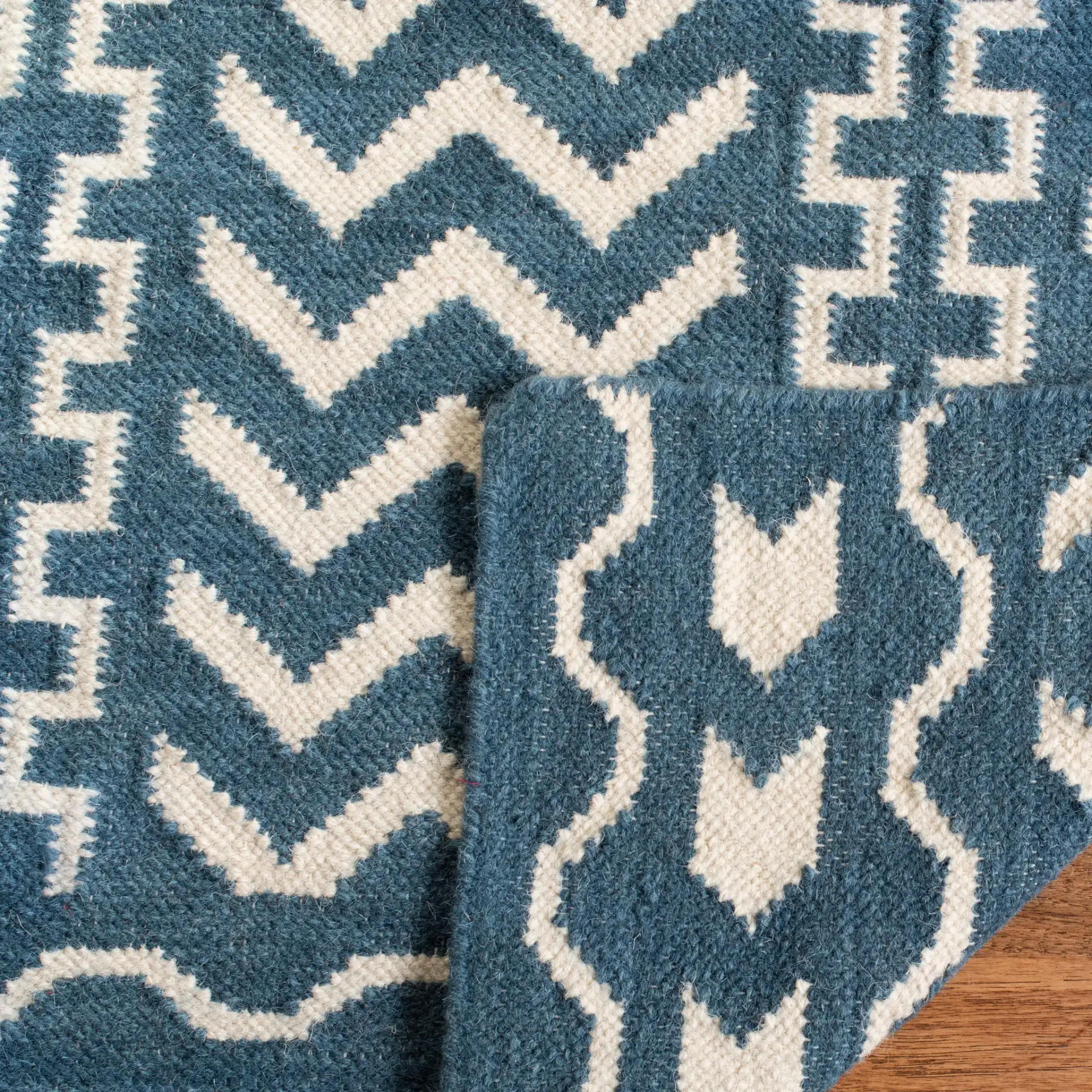 Dhurries Striped Chevron Hand-Woven Rug in Dark Blue / Ivory in a styled room