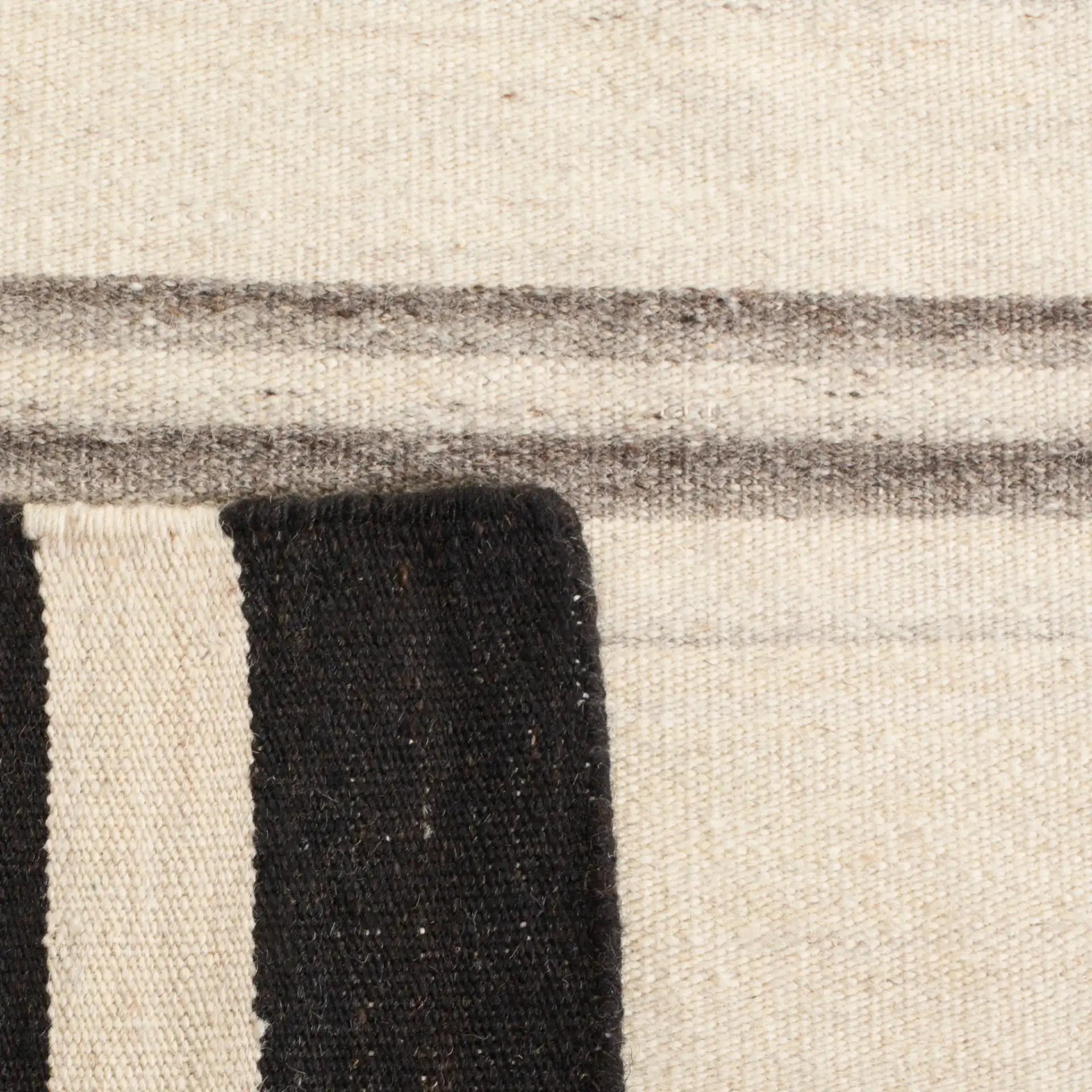 Dhurries Modern Banded Stripe Hand-Woven Wool Rug in Natural / Gray in a styled room
