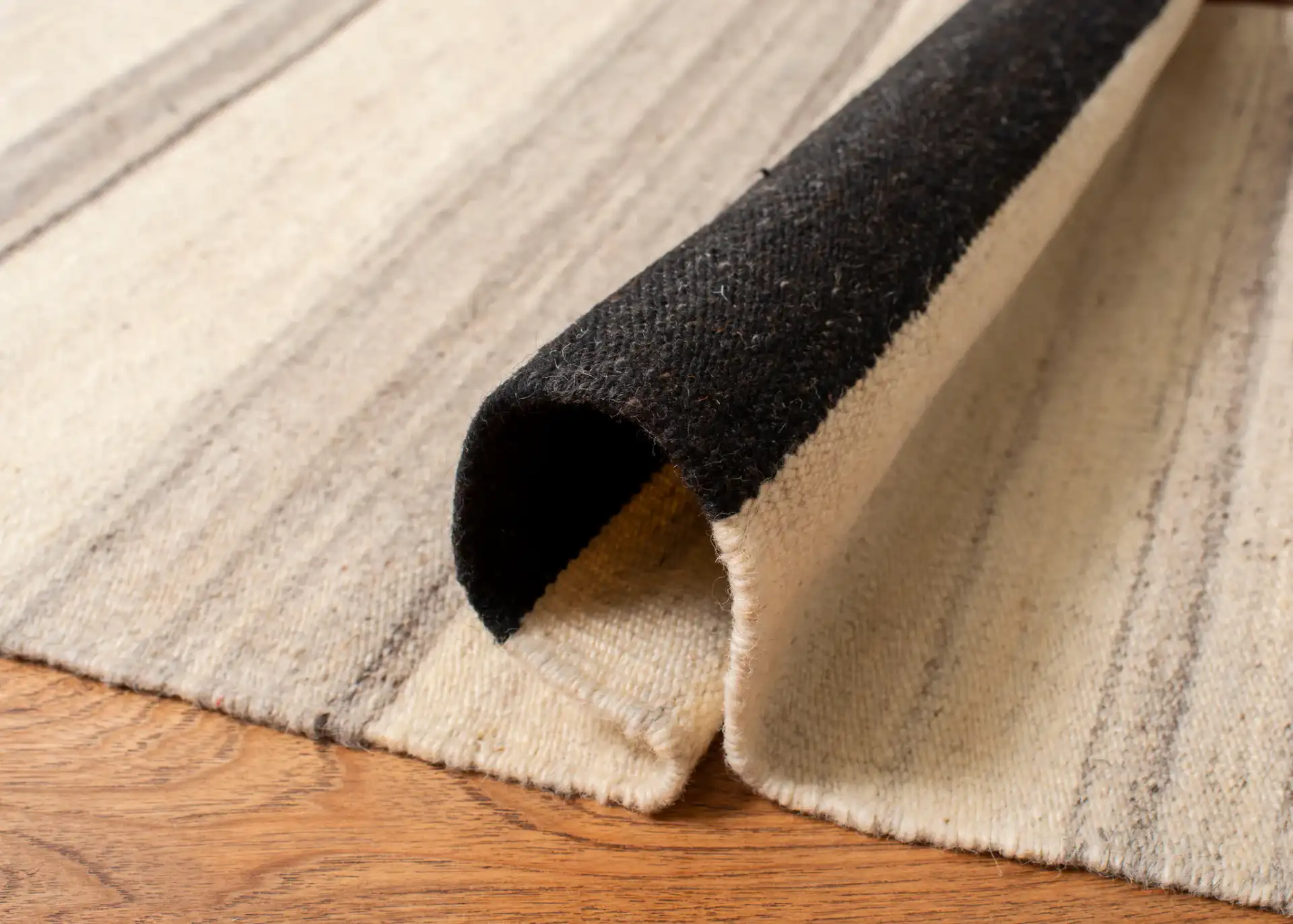 Dhurries Modern Banded Stripe Hand-Woven Wool Rug in Natural / Gray in a styled room