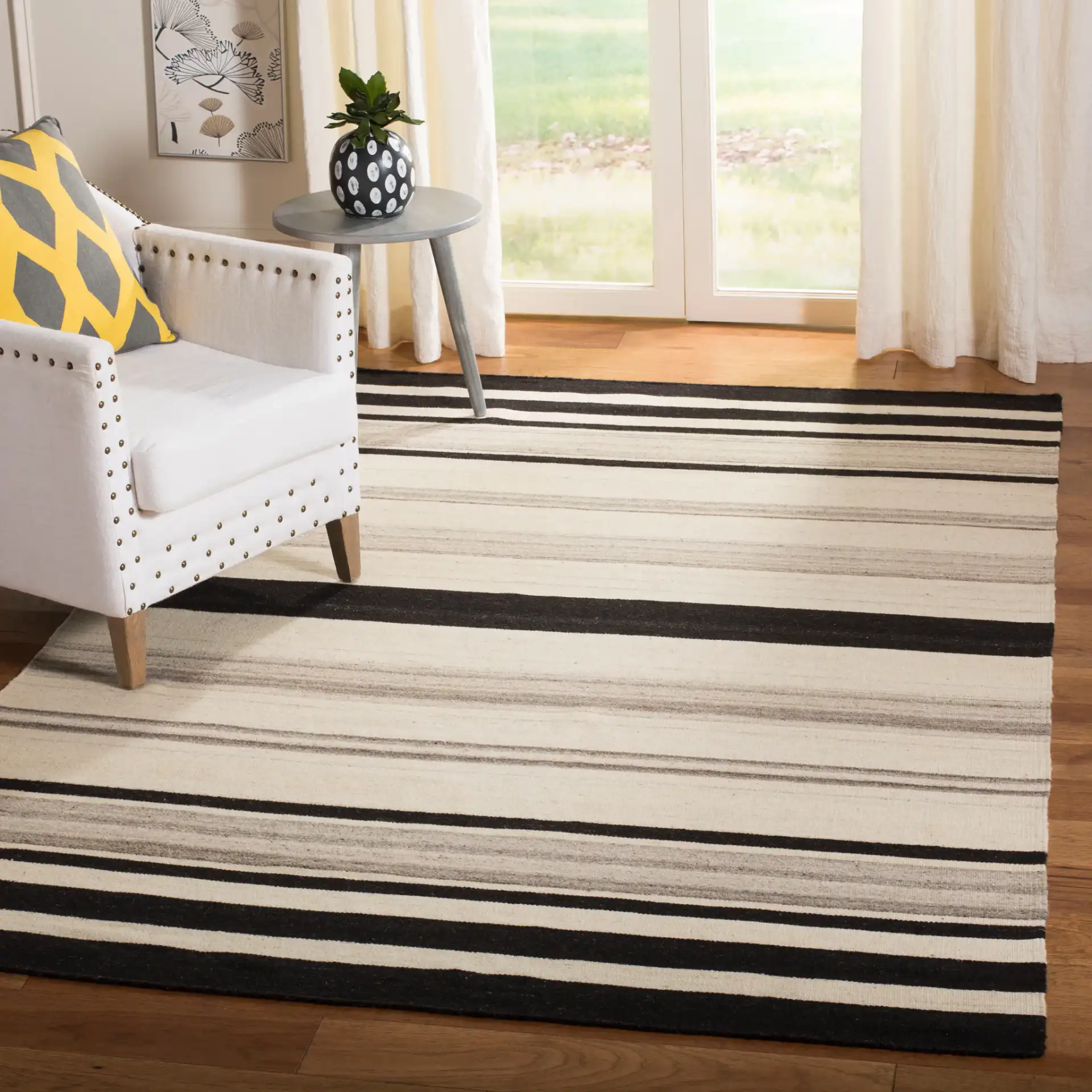 Dhurries Modern Banded Stripe Hand-Woven Wool Rug in Natural / Gray in a styled room