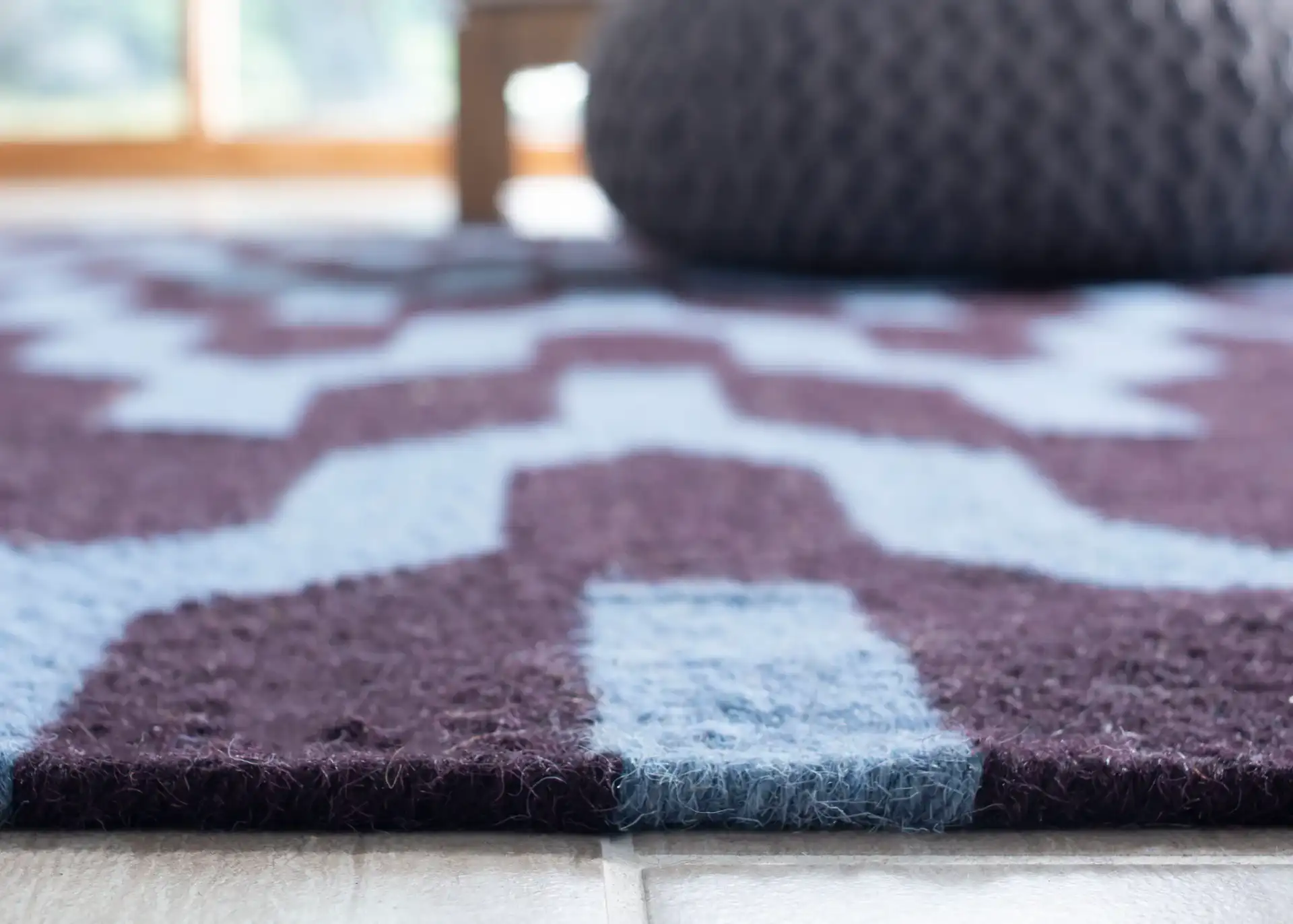Dhurries Interlocking Chevron Hand-Woven Wool Rug in Purple / Blue in a styled room