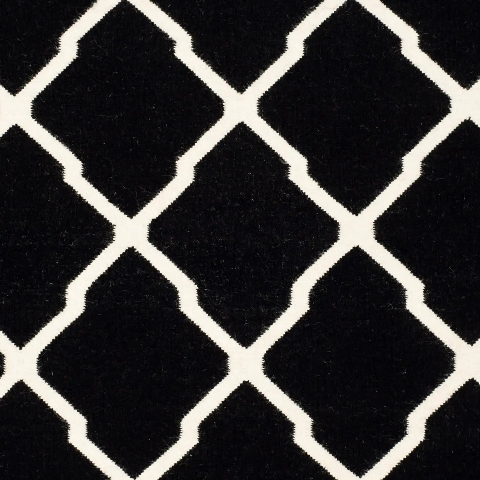 Dhurries Lattice Hand-Woven Wool Rug in Black / Ivory in a styled room
