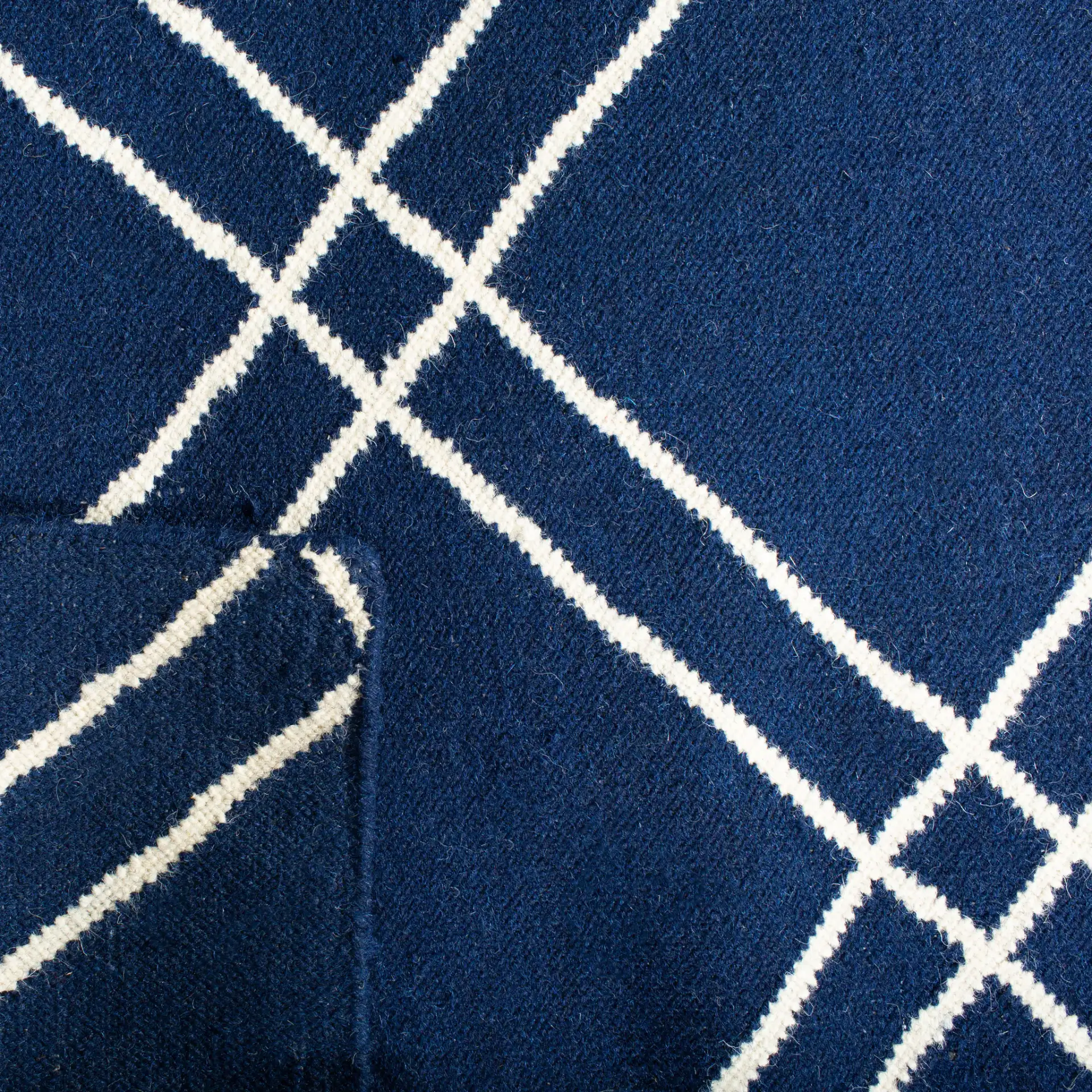 Dhurries Double Diamond Hand-Woven Wool Rug in Navy / Ivory in a styled room