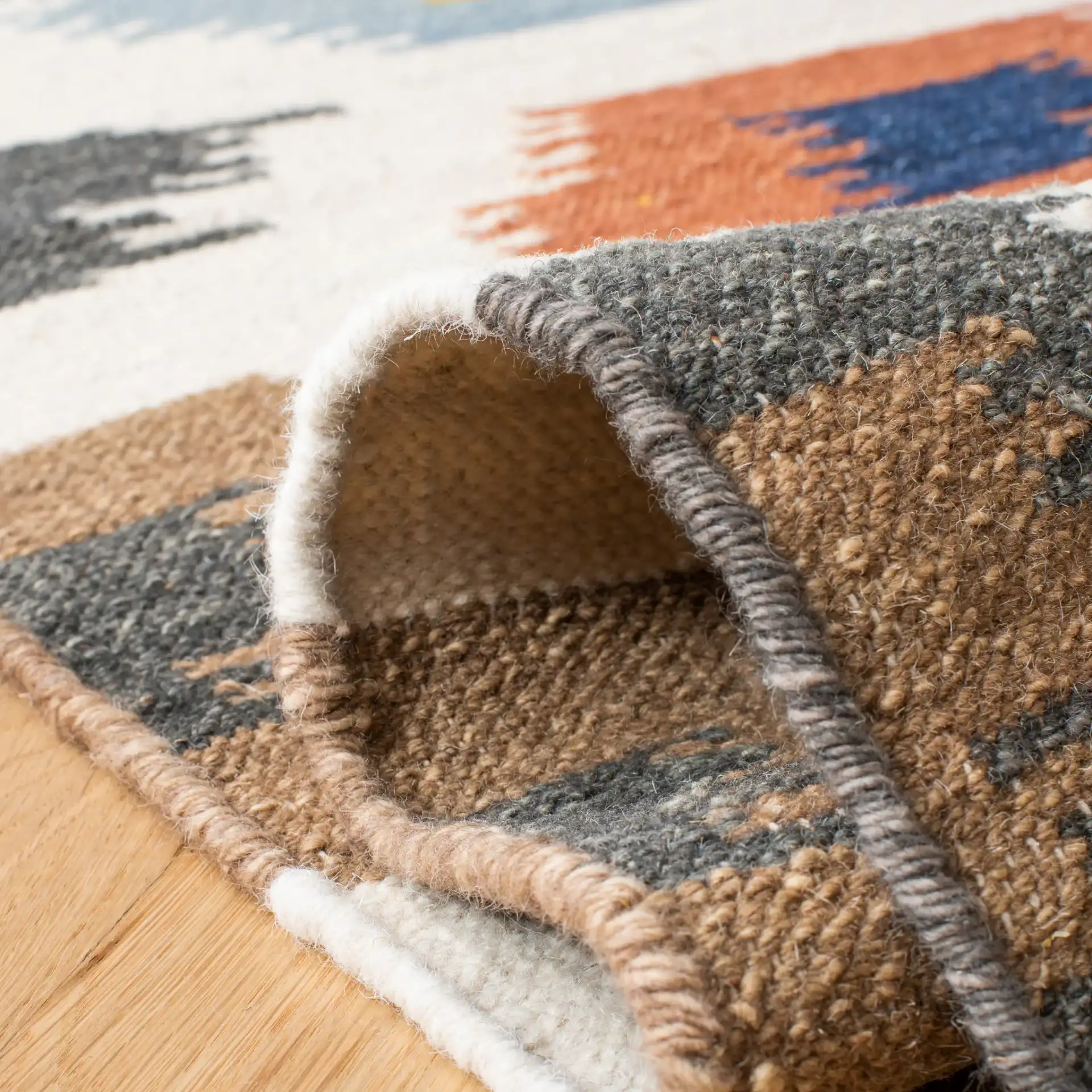 Dhurries Ikat Diamond Hand-Woven Wool Rug in Ivory / Multicolor in a styled room