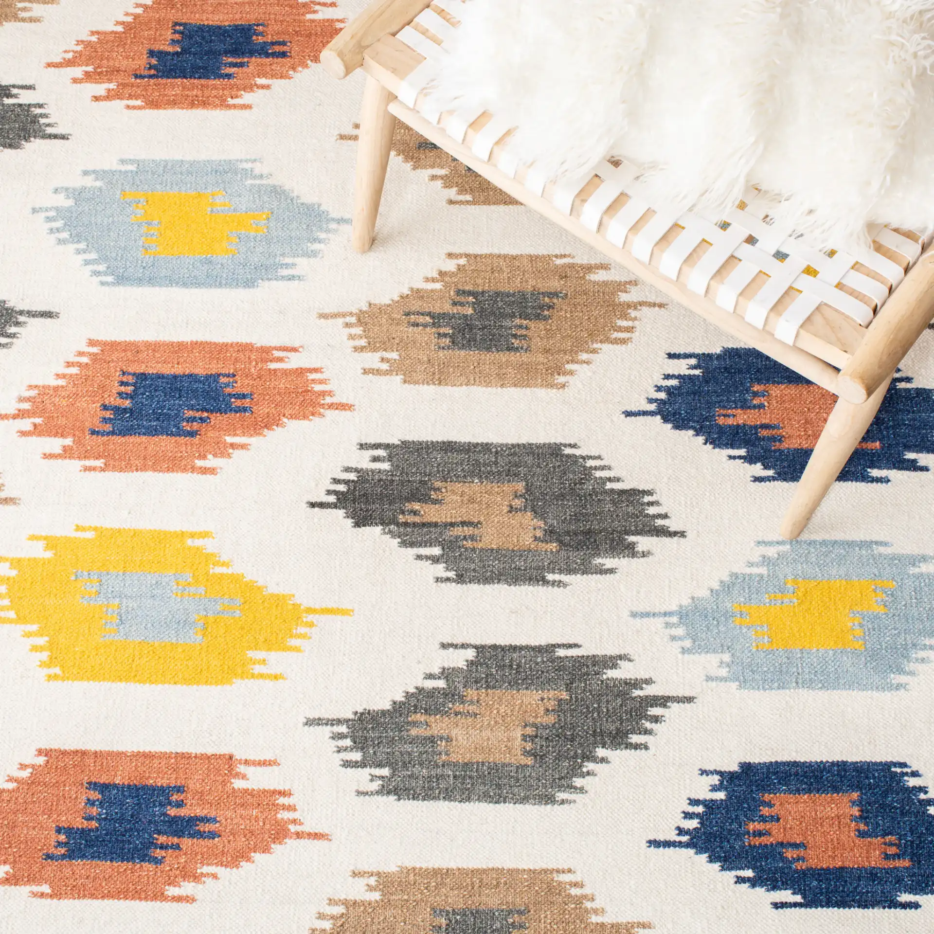 Dhurries Ikat Diamond Hand-Woven Wool Rug in Ivory / Multicolor in a styled room