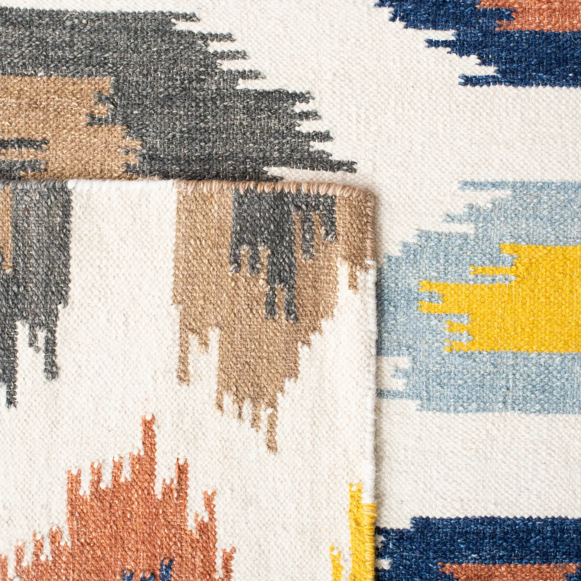 Dhurries Ikat Diamond Hand-Woven Wool Rug in Ivory / Multicolor in a styled room
