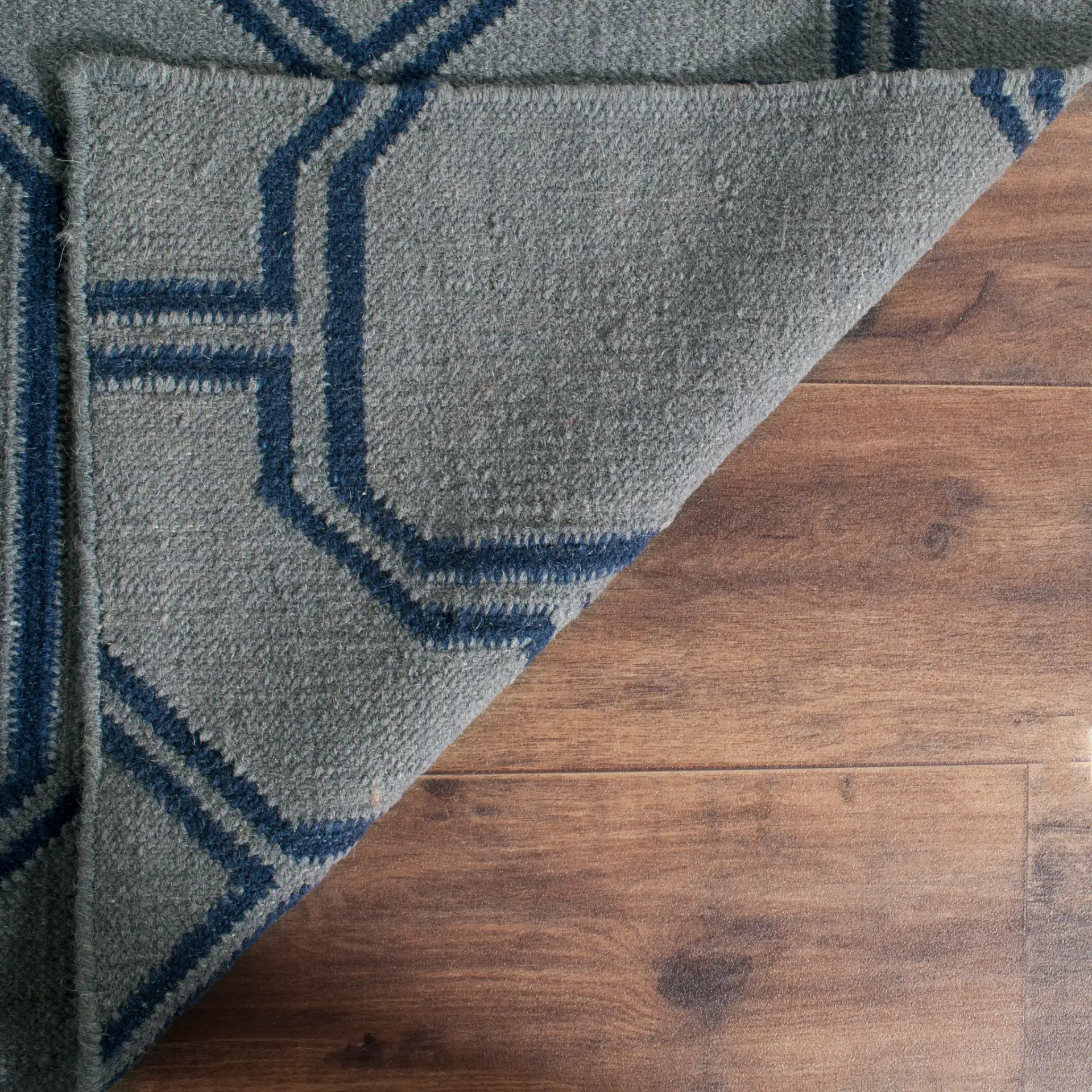 Dhurries Octagon Trellis Hand-Woven Wool Rug in Gray / Dark Blue in a styled room