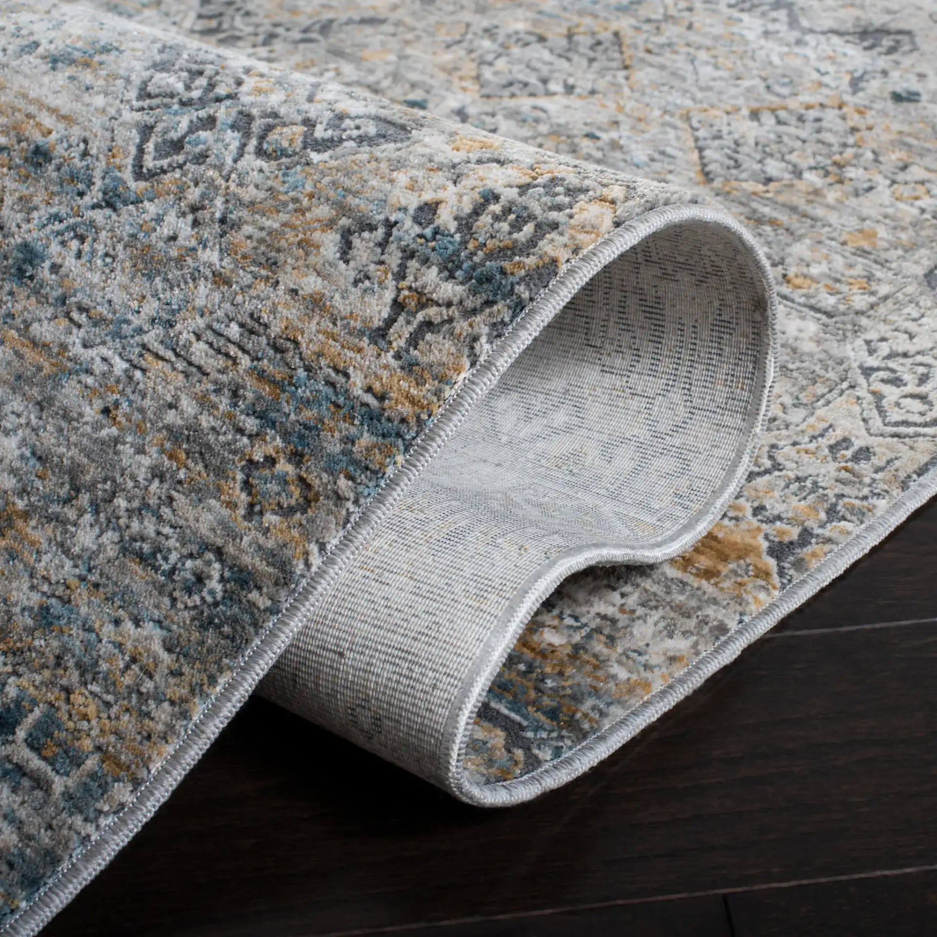 Dream Distressed Geometric Rug in Gray / Gold in a styled room