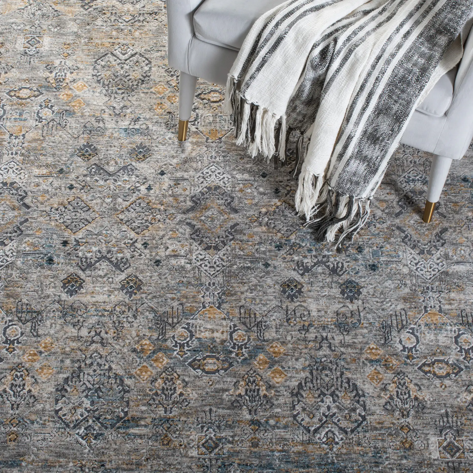 Dream Distressed Geometric Rug in Gray / Gold in a styled room