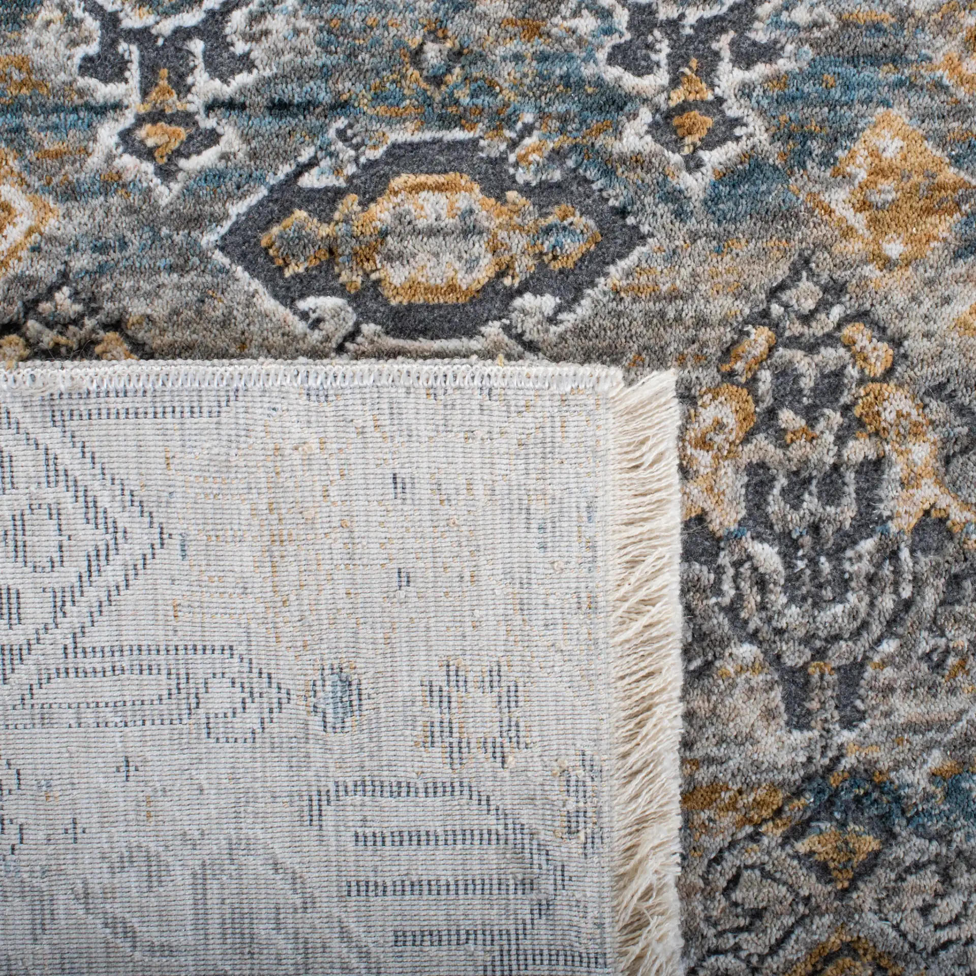Dream Distressed Geometric Rug in Gray / Gold in a styled room