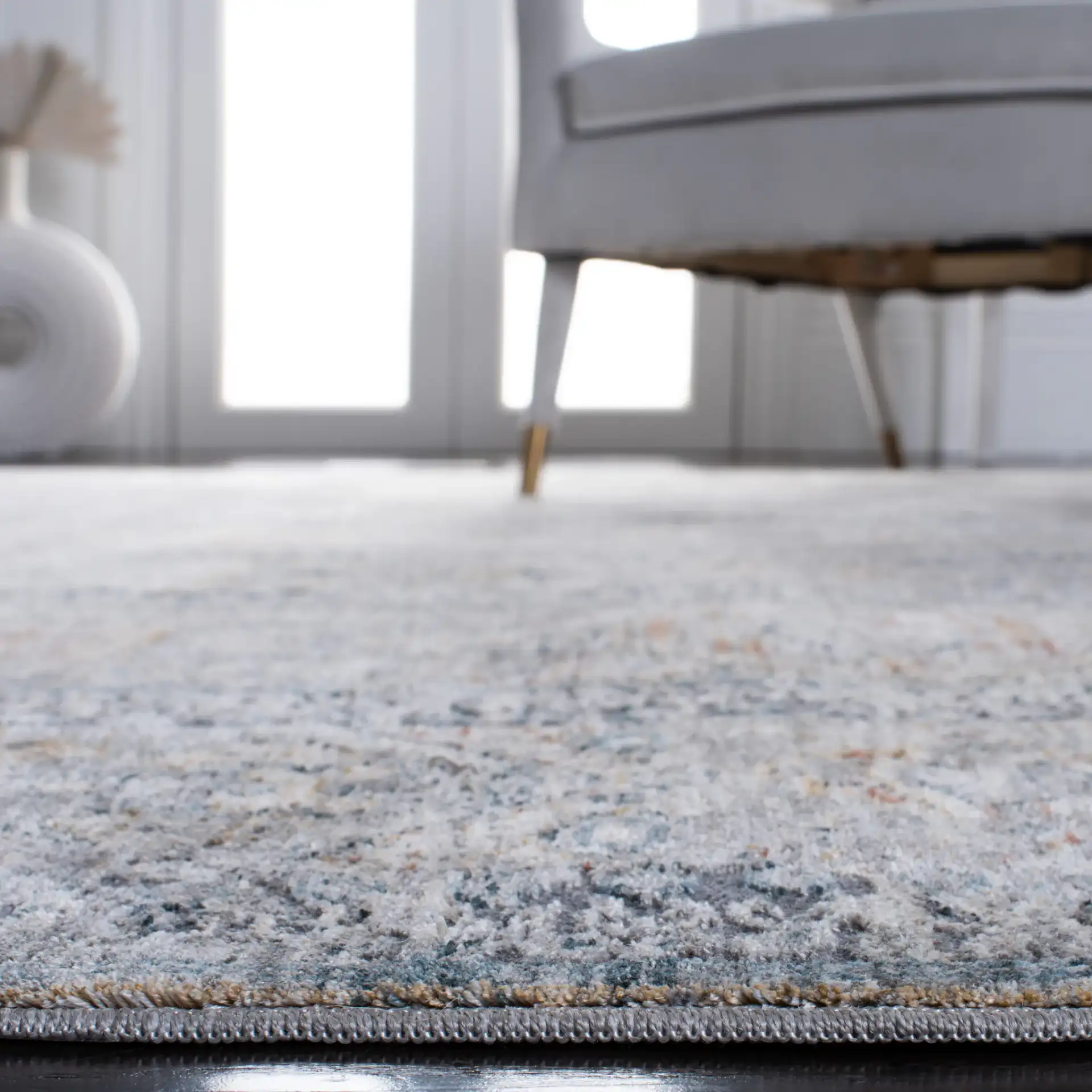 Dream Paneled Medallion Rug in Gray / Gold in a styled room