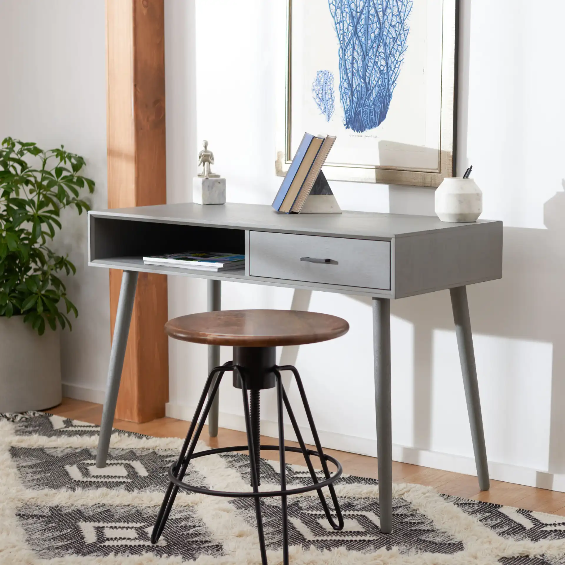 Remy One-Drawer Writing Desk in Distressed Gray in a styled room