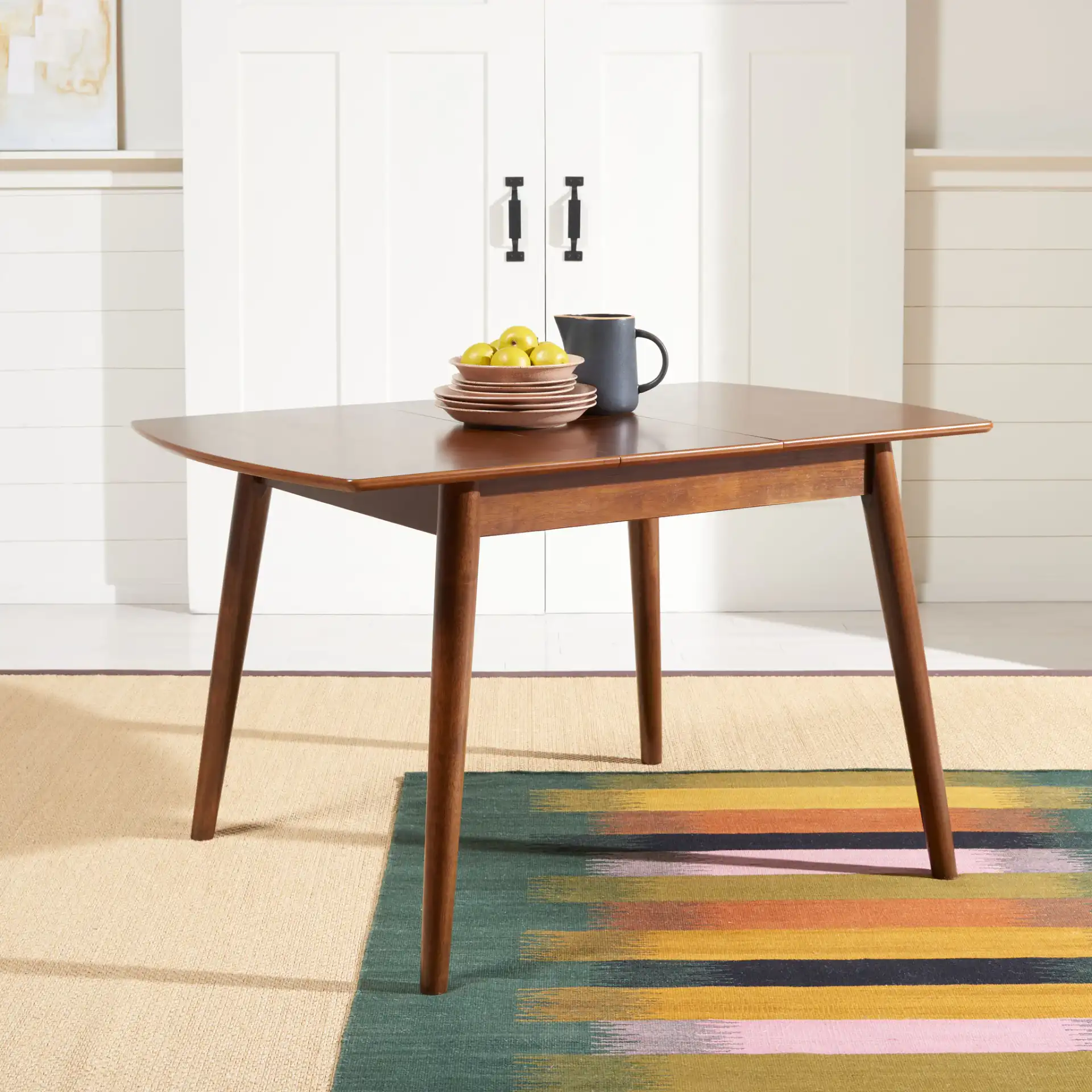 Varda Manual Extension Dining Table in Walnut in a styled room
