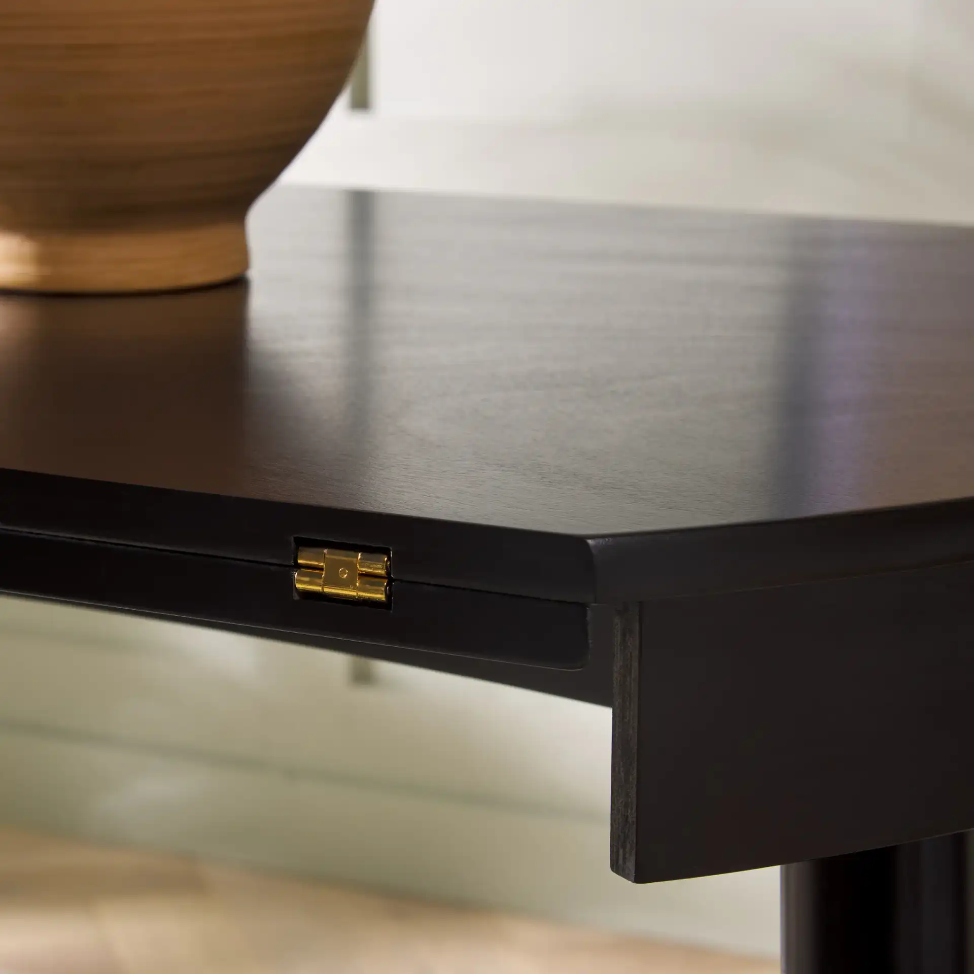 Malakai Folding Round Dining Table in Black in a styled room