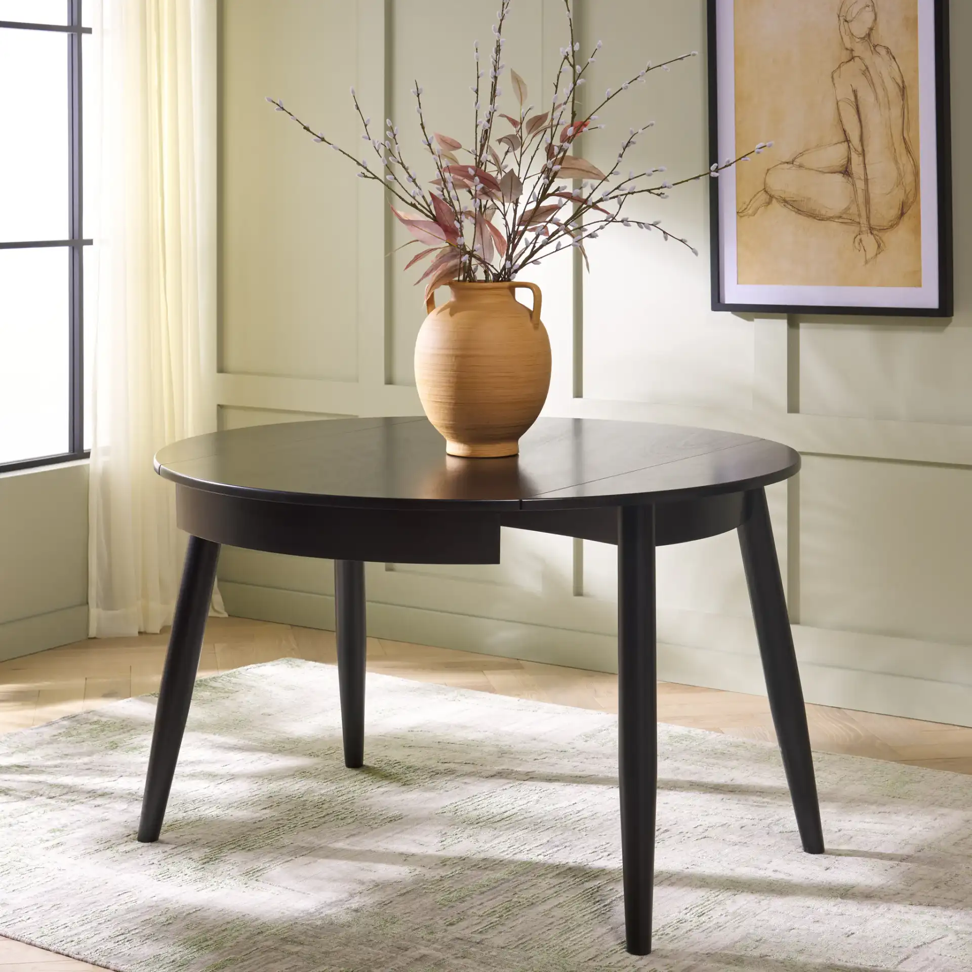 Malakai Folding Round Dining Table in Black in a styled room