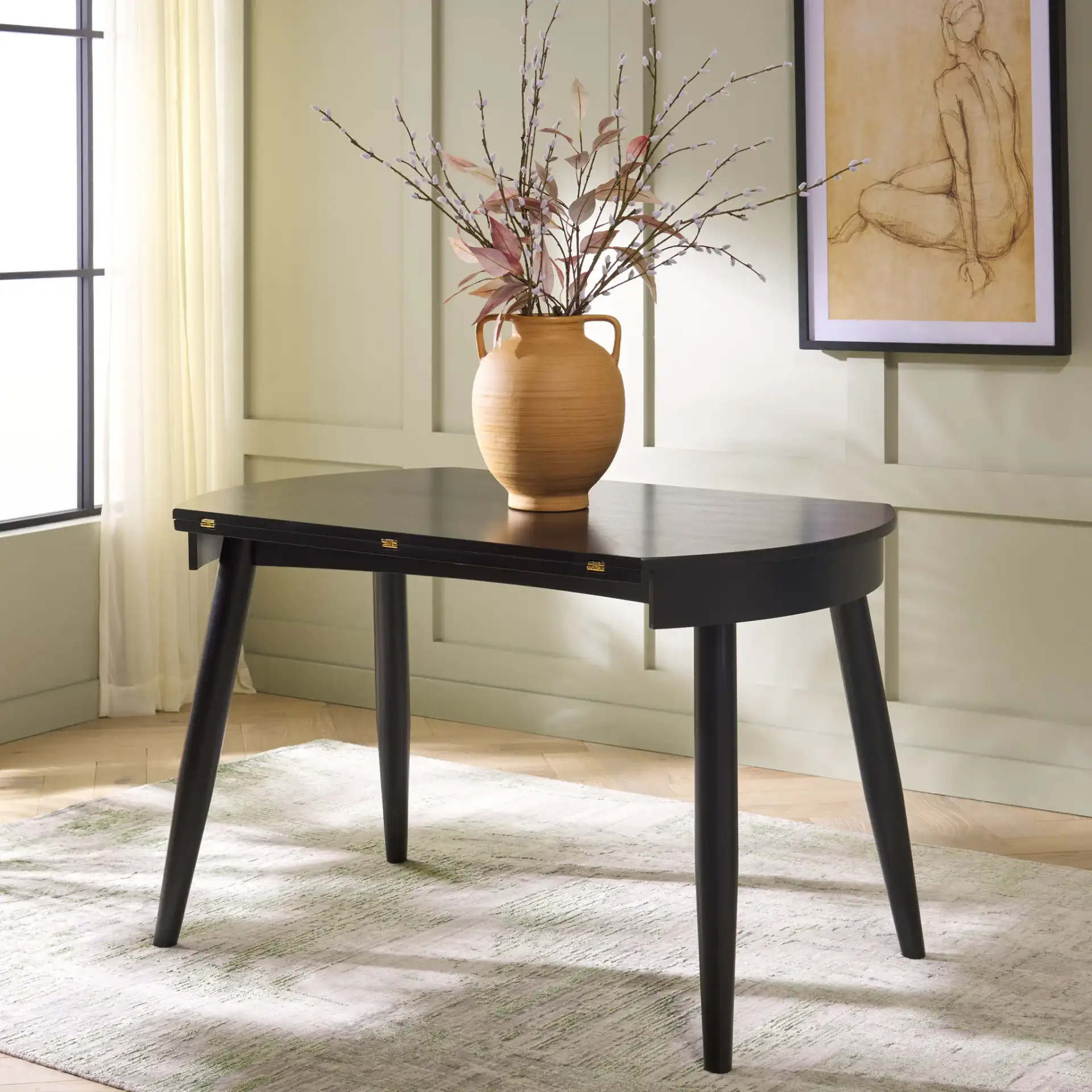 Malakai Folding Round Dining Table in Black in a styled room