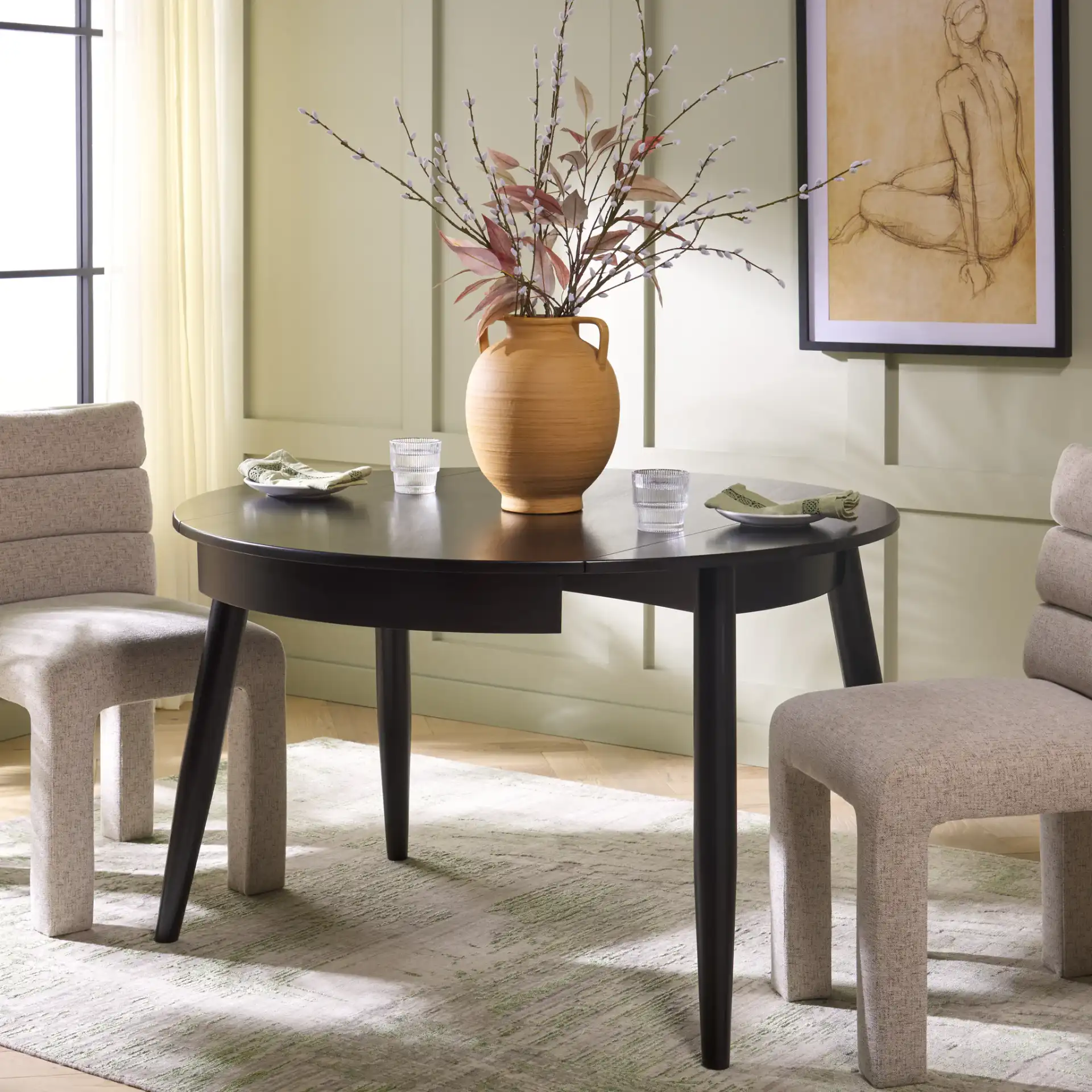 Malakai Folding Round Dining Table in Black in a styled room