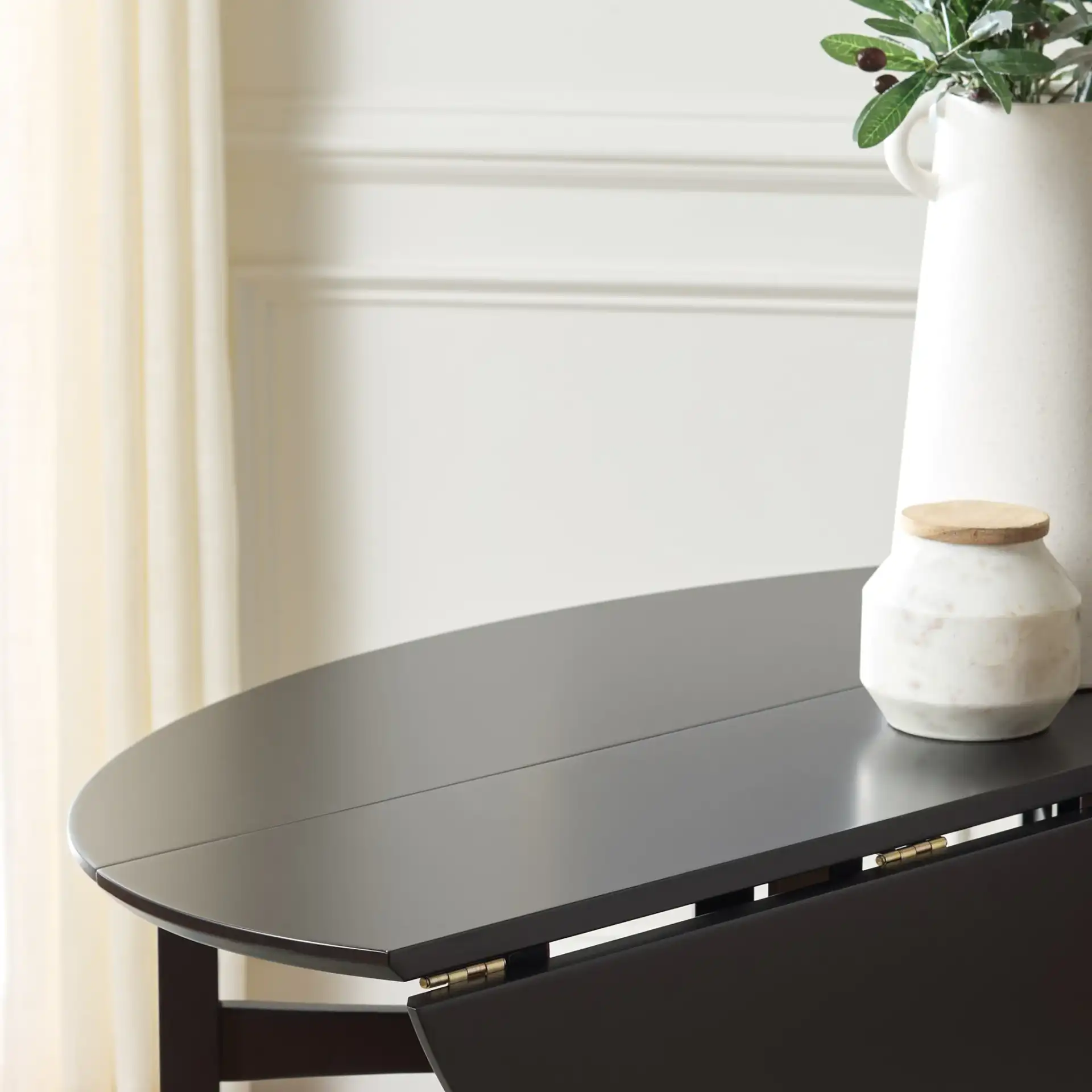 Roz Folding Round Dining Table in Black in a styled room