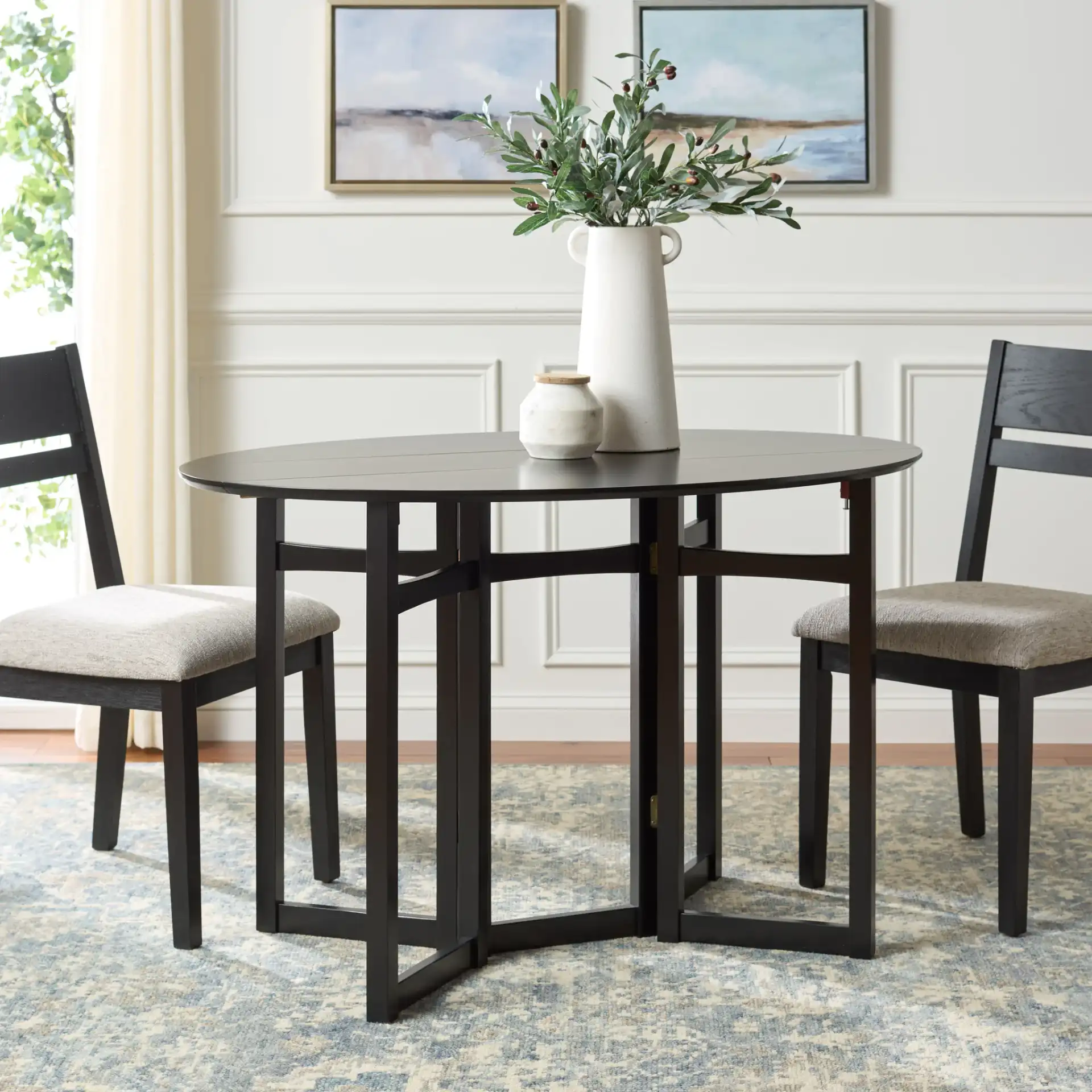 Roz Folding Round Dining Table in Black in a styled room