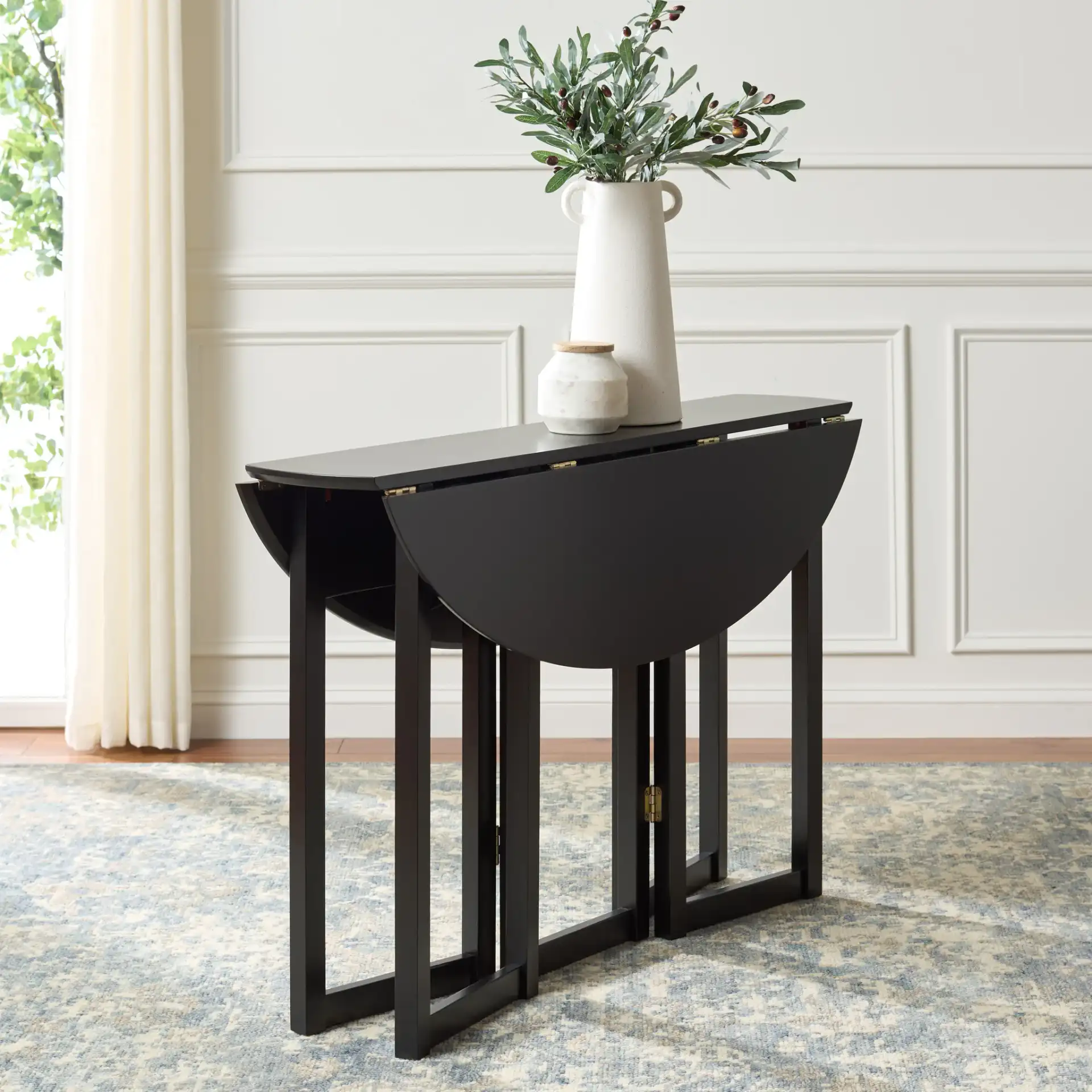 Roz Folding Round Dining Table in Black in a styled room