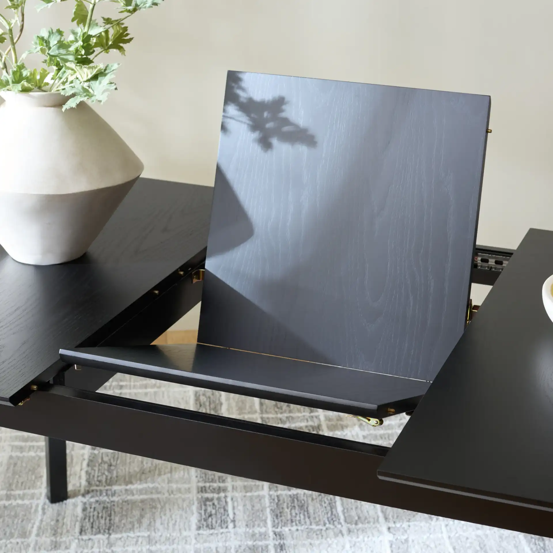 Hammis Extendable Dining Table in Black in a styled room
