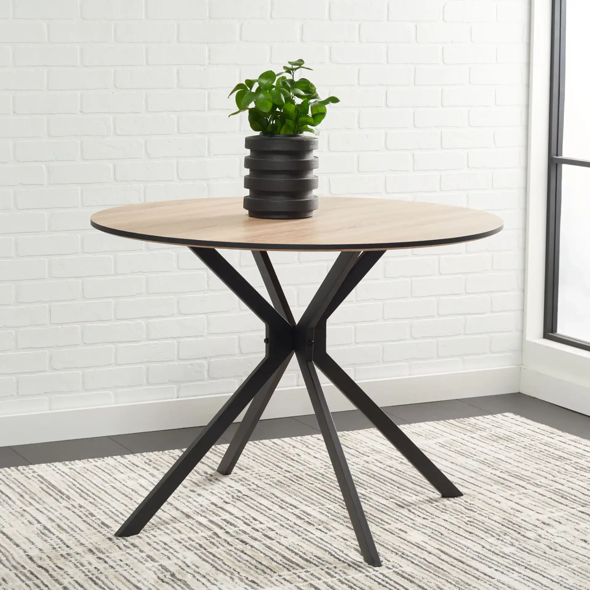 Rixley Dining Table in Natural / Black in a styled room
