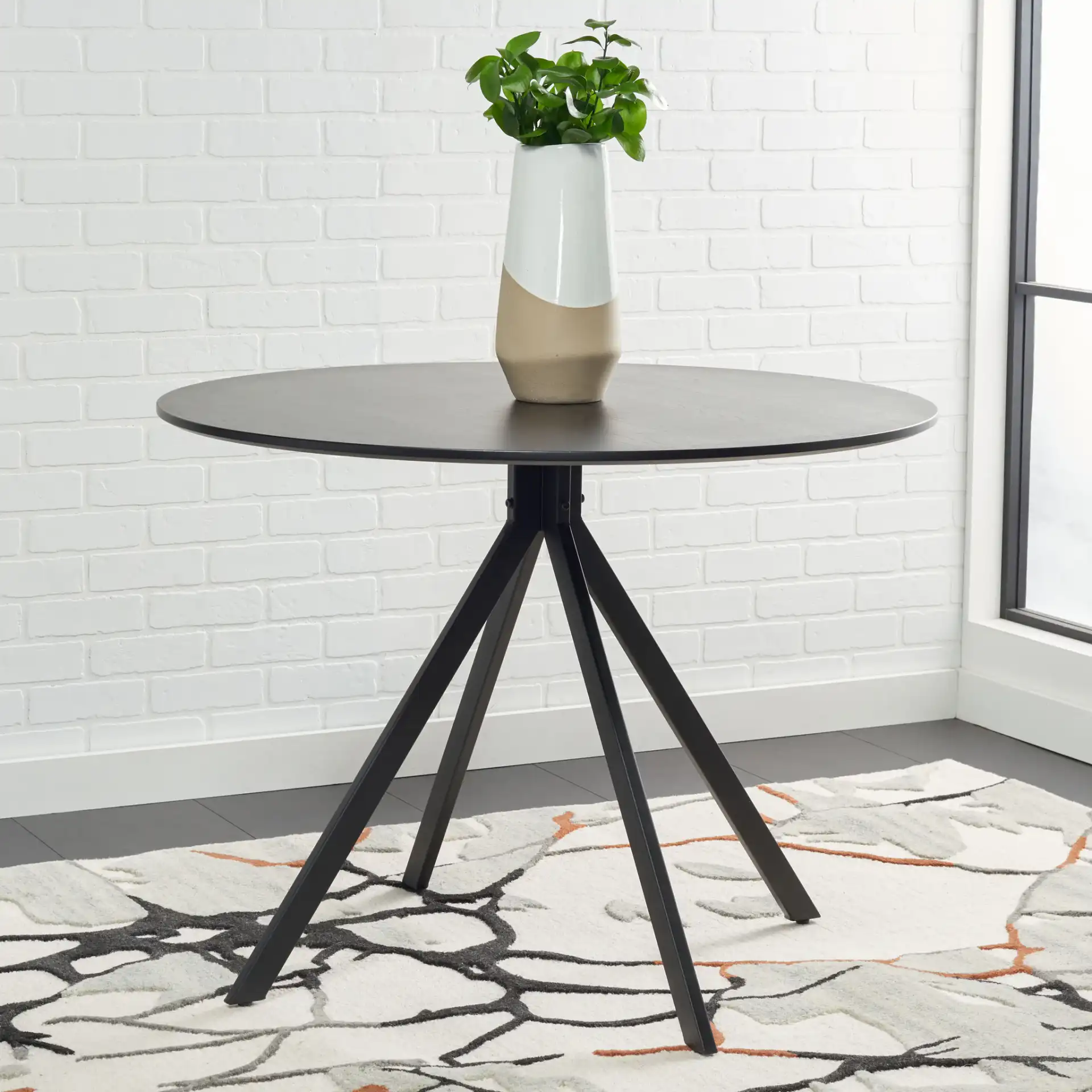 Skyden Dining Table in Black in a styled room