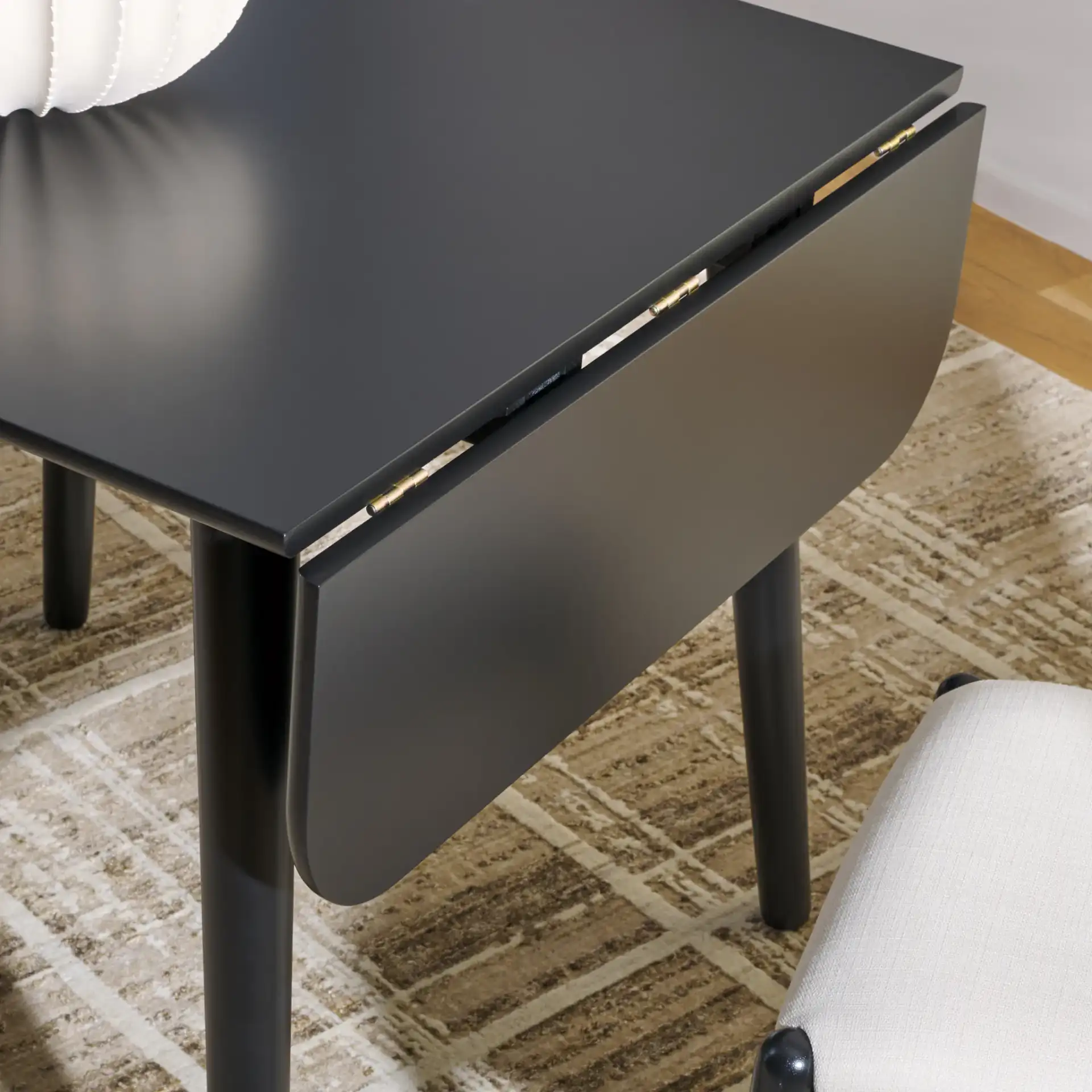 Damarius Drop Leaf Table in Matte Black in a styled room