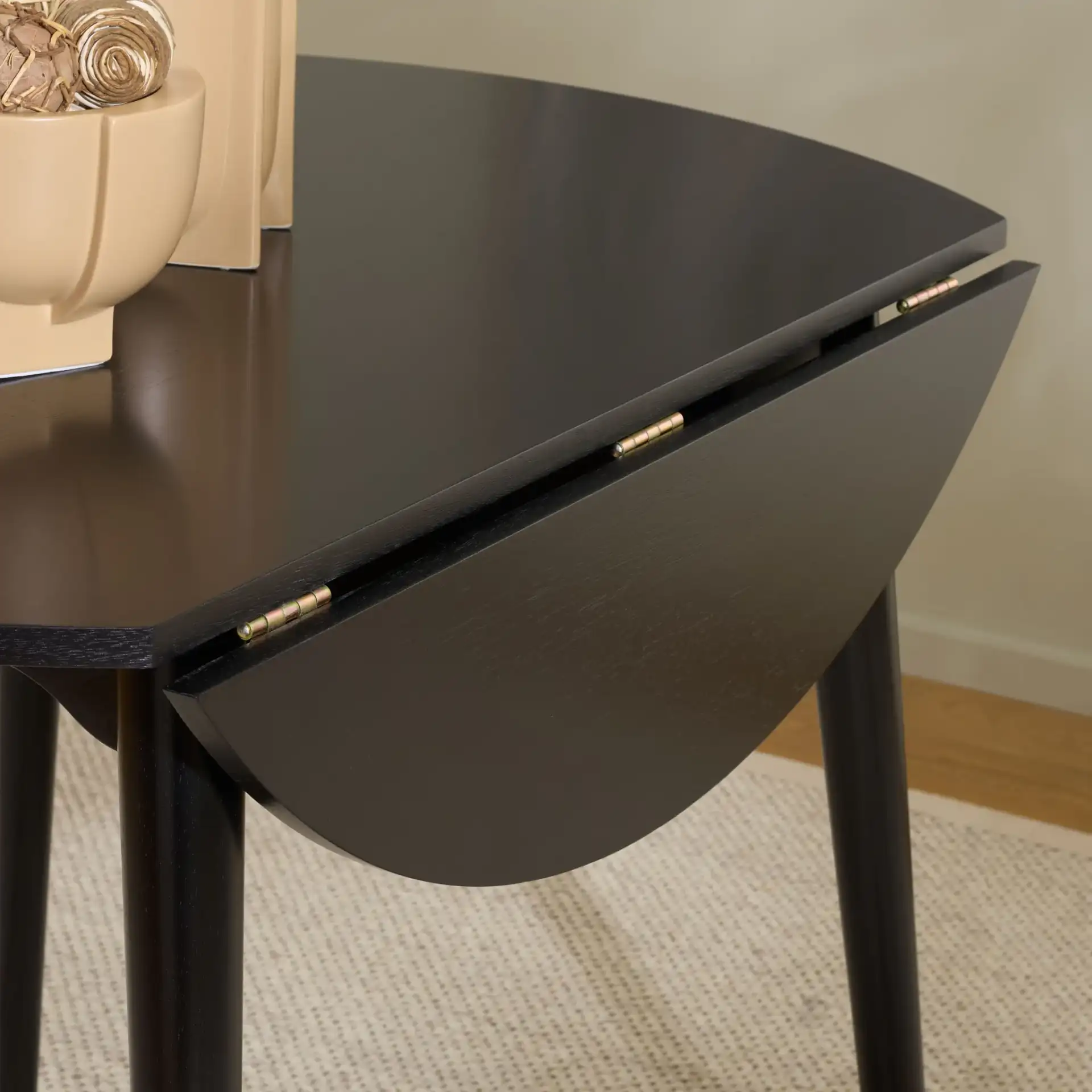 Roma Round Drop Leaf Scallop Table in Black in a styled room